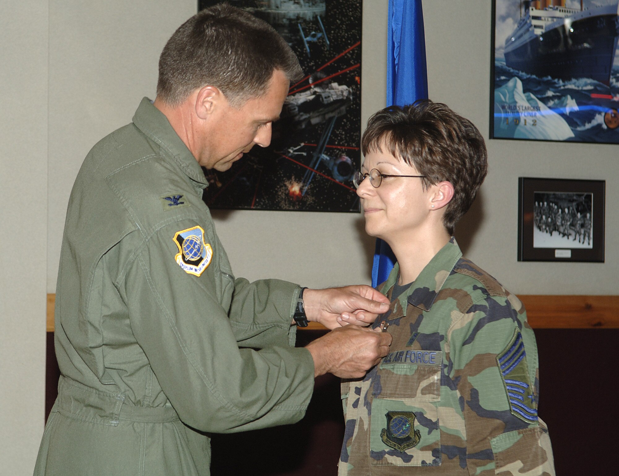 Chief Master Sgt. Judith Ruiz stands at attention as Col. Scott Hanson, 92nd Air Refueling Wing commander, pins the Meritorious Service Medal onto her uniform. The medal was awarded to Chief Ruiz for her service as the superintendent of the 92nd Medical Group. The chief currently serves as the interim command chief. (U.S. Air Force photo/ Senior Airman Chad Watkins)