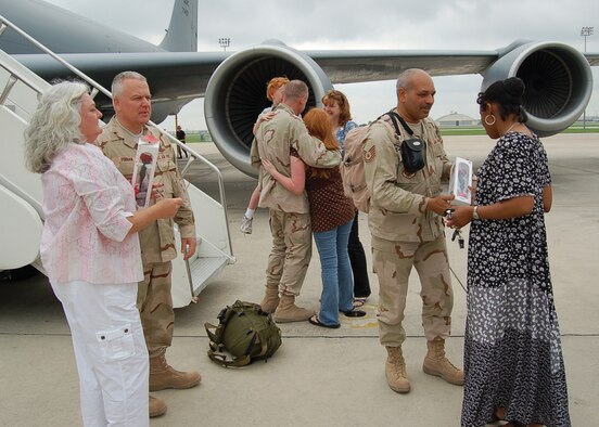 Brigadier General John Fobian (left), 433rd Airlift Wing Commander, is welcomed home by his wife, Kim, and members of the Alamo Wing on May 2, 2007. Tech. Sgt. Raffael Dickerson (right) and Maj. Mike Nelson, also from the 433rd AW, are also greeted by family on thier arrival. General Fobian served as the Director of Mobility Forces, Major Nelson served as General Fobian's executive officer and Sergeant Dickerson as his administrative assistant during thier deployment to the Combined Air Operations Center in Southwest Asia. (U.S. Air Force Photo/ Master Sgt. Collen McGee)