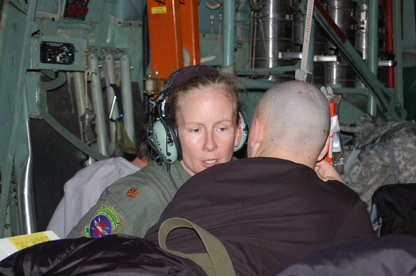 Maj. Lisa Willis, a flight nurse with the 433rd Aeromedical Evacuation Squadron, is currently serving at Scott AFB, Ill. She is one of several Alamo Wing members who fly wounded troops from Scott AFB to Texas. "Sometimes they need to talk," said Major Willis during a crew briefing on April 30. She puts that to practice during a flight from Scott AFB to Lackland's Kelly Field the same day. (U.S. Air Force Photo/Master Sgt. Collen McGee)
