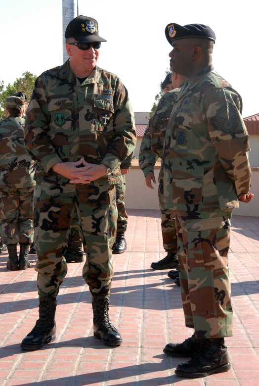 Col. Bryan Gallagher (left), 95th Air Base Wing commander, talks to Senior Master Sgt. Novelt Mack, 95th Security Forces Squadron operations superintendent,during the Police Week commemoration of fallen police officers Tuesday at the Air Force Flight Test Center headquarters building. (Photo by Airman Mike Young)