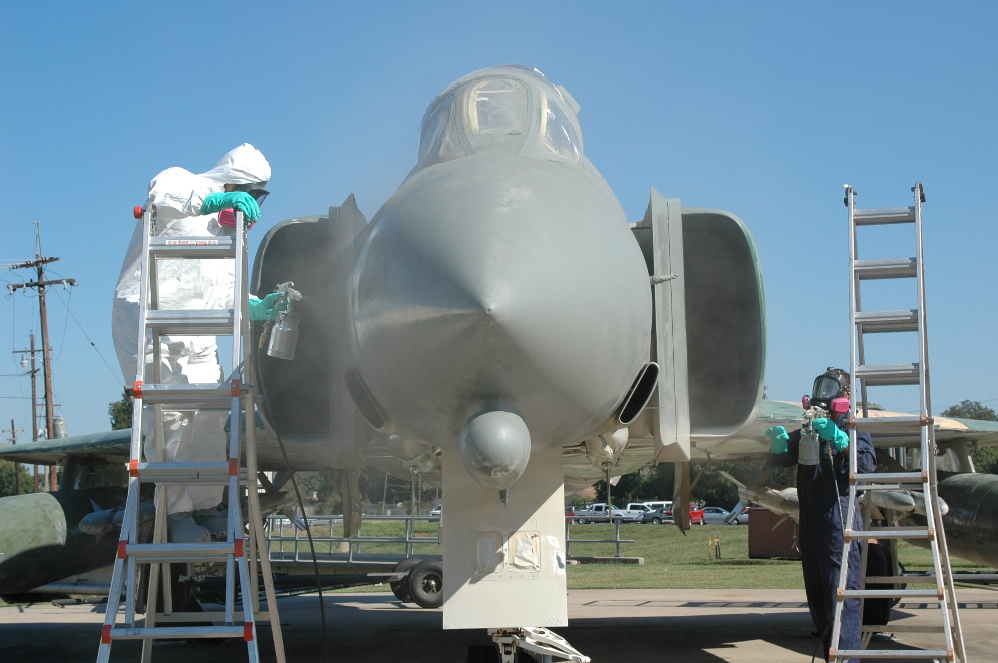 Rick Hunter and Cartria Carthern,  technical sergeants in the 917th Maintenance Squadron, paints the F-4 Sept. 27, 2006. (U.S. Air Force photo/Tech. Sgt. Sherri Bohannon)