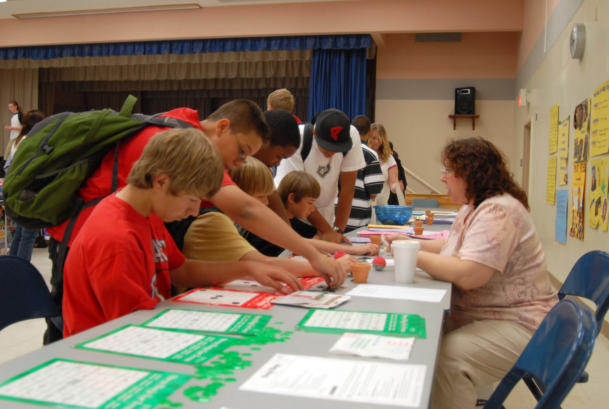 Karen DeSocio (right), with the Family Advocacy Program, entertains students with a game of bingo that focuses on teen health during the Teen Health Fair on May 11 at Forbes Elementary School here. (Photo by Airman Mike Young)