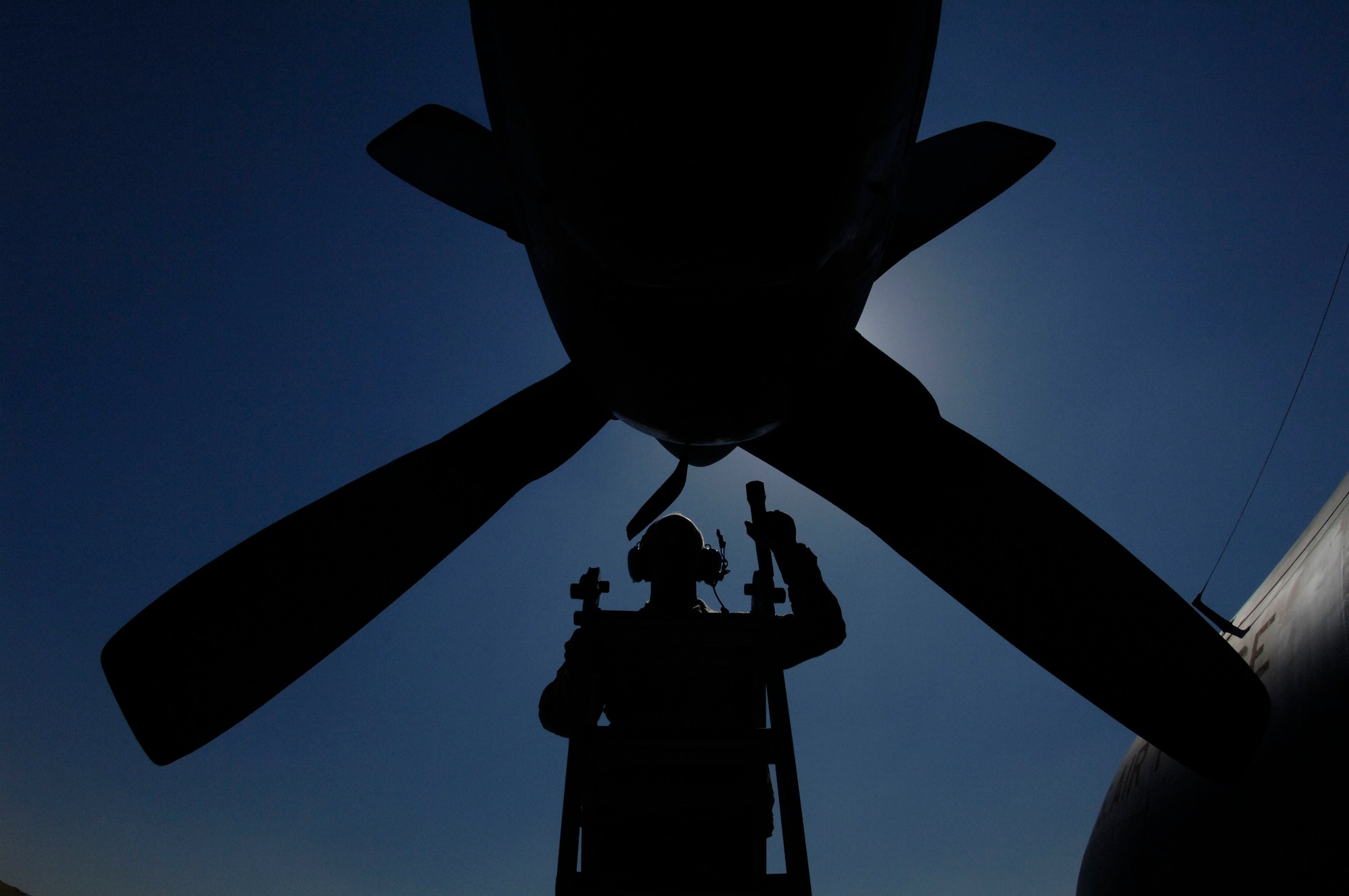An Air Force C-130 Hercules maintainer examines one of the aircraft's four propeller-driven engines at a base in Southwest Asia.  Coalition C-130s and C-17 Globemaster IIIs delivered more than 510 tons of supplies and transported more than 3,600 people May 14.  The C-130 has been in use in the U.S. for more than 50 years.  More than 40 models and variations of the Hercules serve in more than 50 nations.  (U.S. Air Force photo/Staff Sgt. David Miller)