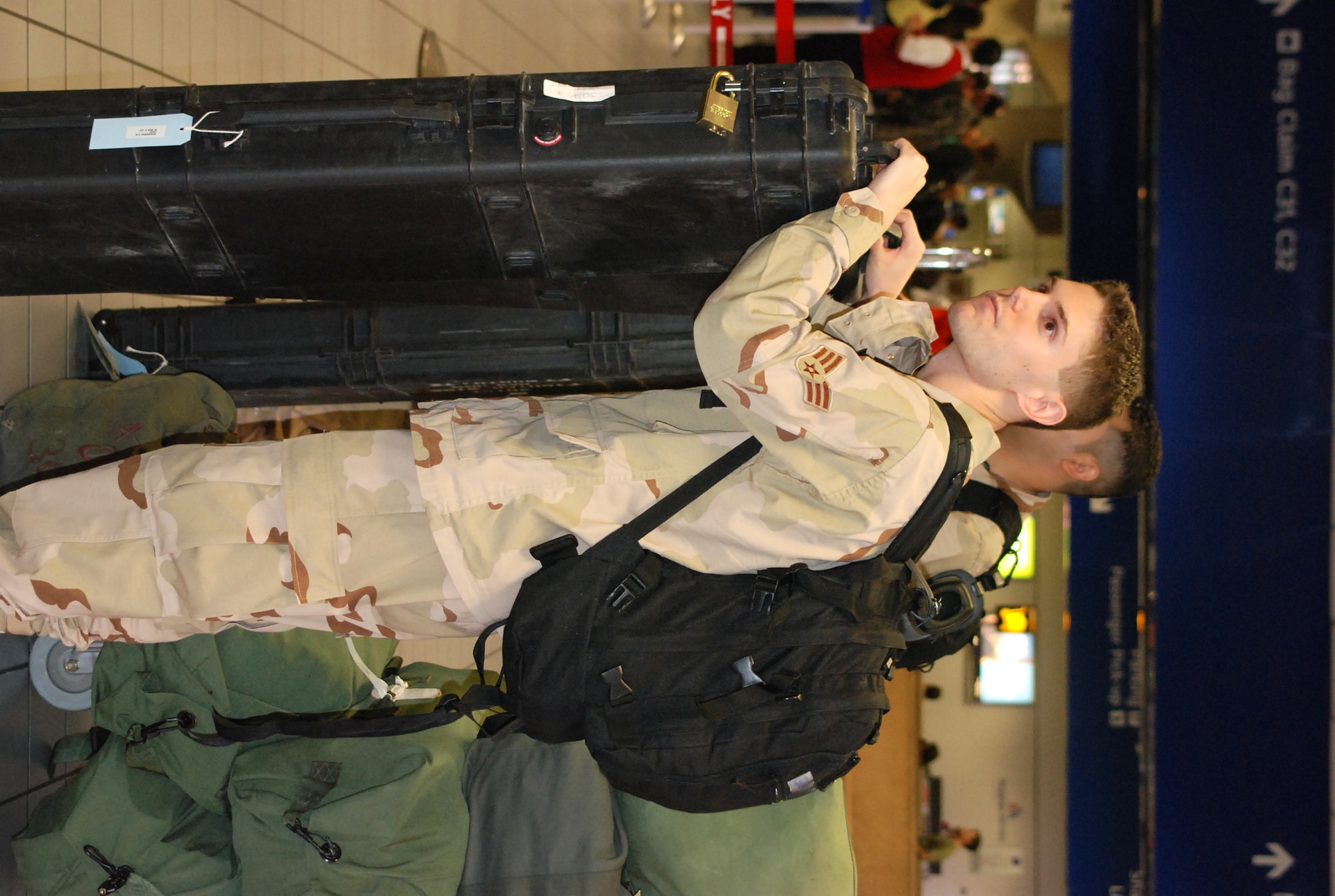 301st Fighter Wing members wait to check in their bags before leaving Dallas/Fort Worth International Airport on their way to Southwest Asia. Nearly 300 301st Fighter Wing troops deployed recently to support the current Aerospace Expeditionary Force cycles. (U.S. Air Force Photo/Tech. Sgt. Julie Briden-Garcia) 