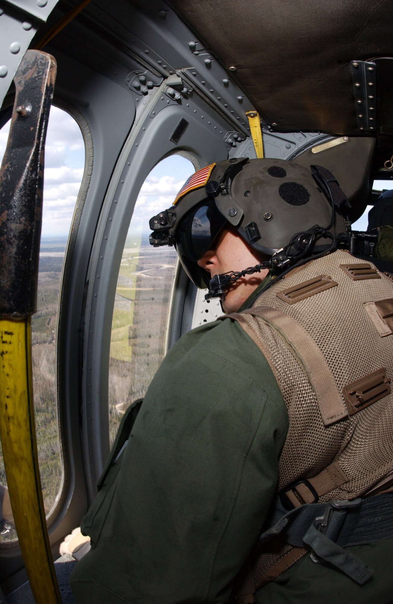Staff Sgt. Ken Gillum scans the terrain for suspicious activity during Exercise Northern Edge May 10 over the Trans-Alaska Pipeline System. The joint training exercise is designed to practice operations, techniques and procedures and enhance interoperability among all the services and civilian emergency response teams. Sergeant Gillum is an aerial gunner assigned to Det. 1, 210th Rescue Squadron. (U.S. Air Force photo/Airman 1st Class Jonathan Snyder)
