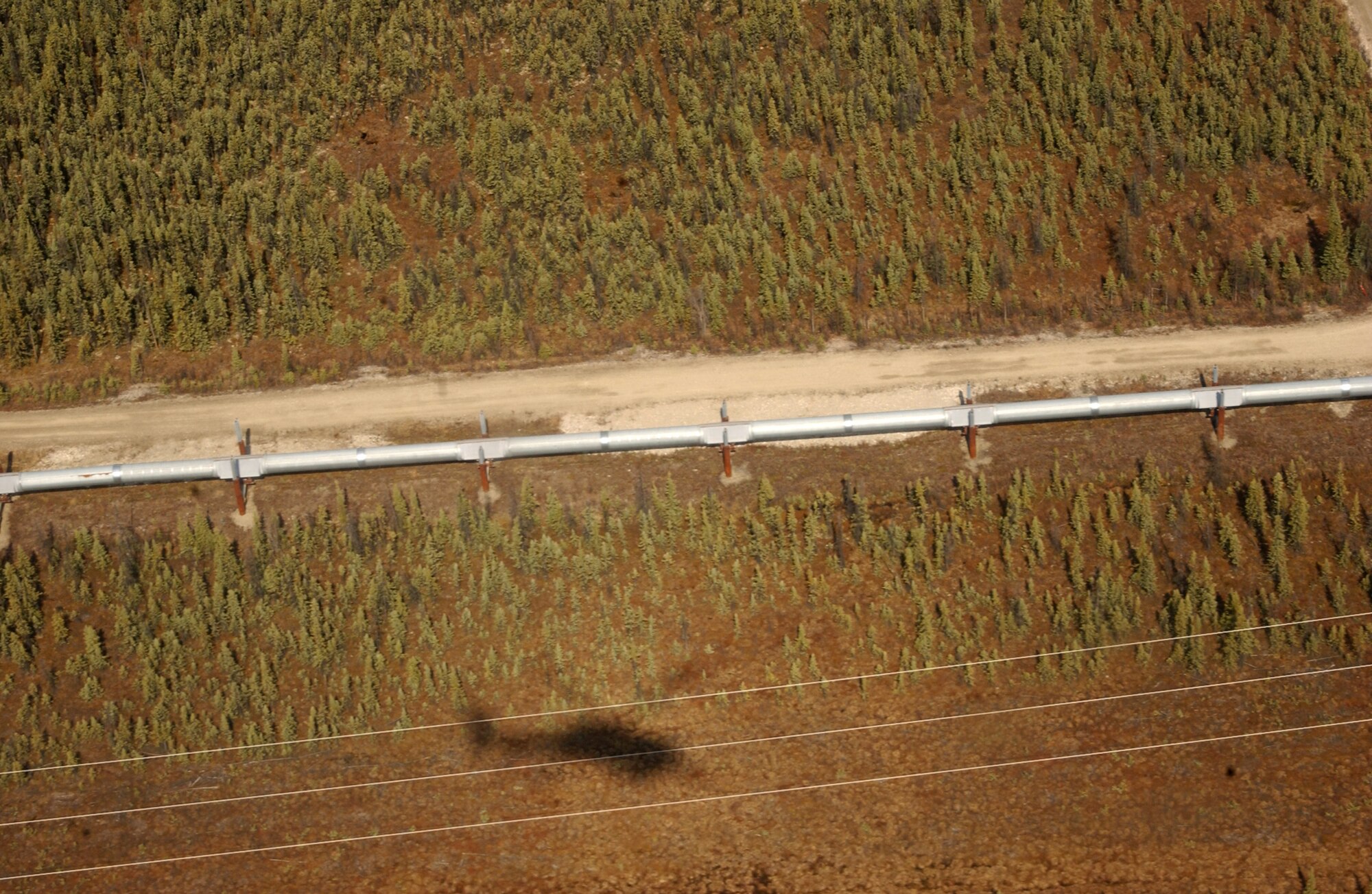 The Trans-Alaska Pipeline System is being scanned for suspicious activity by an aircrew on board an HH-60G Pave Hawk during Northern Edge May 10. The TAPS runs north to south, almost 800 miles from Prudhoe Bay to Valdez. During this exercise, Airmen from the 210th Rescue Squadron patrolled from Livengood to Delta covering 172 miles. The HH-60 Pave Hawk is assigned to the 210th RSQ at Eielson Air Force Base, Alaska. (U.S. Air Force photo/Airman 1st Class Jonathan Snyder)
