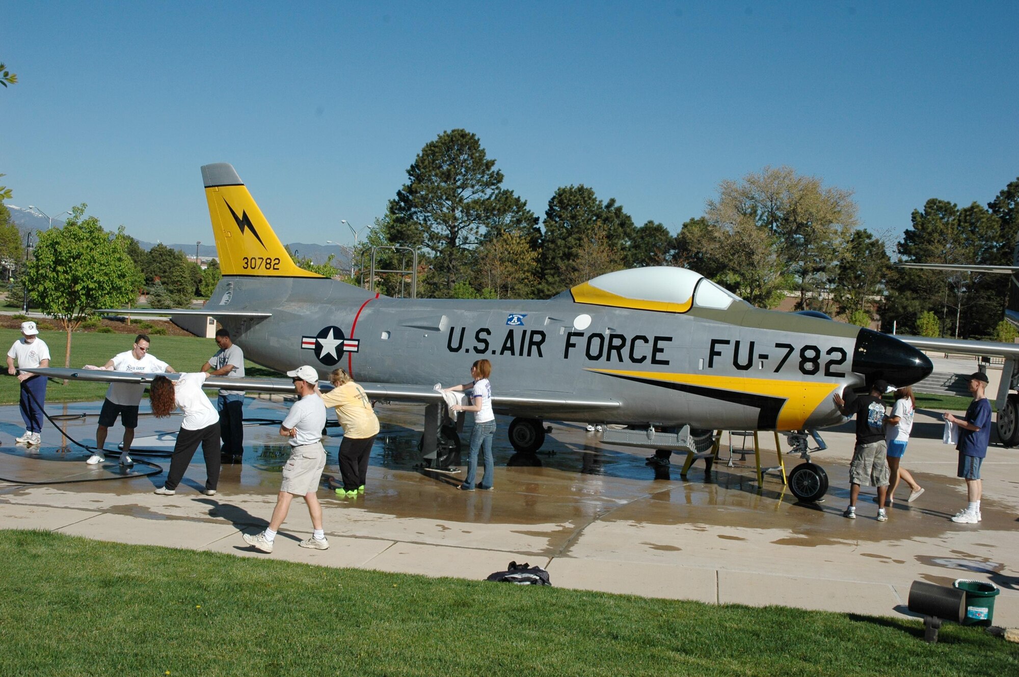 About 25 volunteers from the 21st Space Wing Director of Staff wash an F-86L “Dog Sabre” May 11 at the Peterson Museum. The unit “adopted” the aircraft, and wash it three times each year, giving it a coat of wax once a year. The group moved quickly, and had enough time to wash an additional craft which has not been adopted yet.
The museum has 17 aircraft, including three Army missiles, on display and needs volunteers to adopt seven of them. To adopt an aircraft, call the museum at 556-8314. (U.S. Air Force photo by Steve Brady)