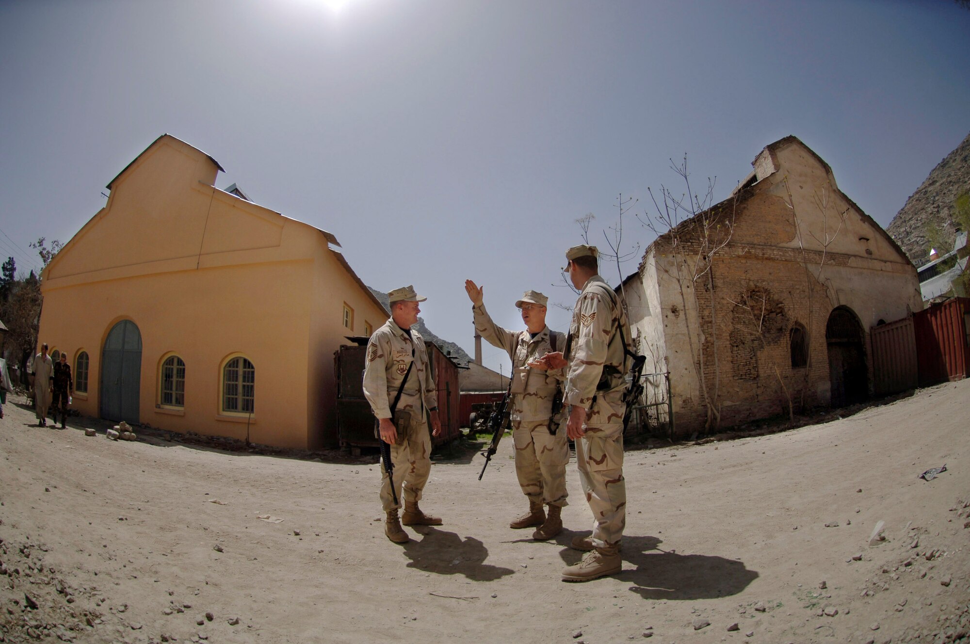 Senior Master Sgt. Alfed Marasse, Maj. James Wood and Staff Sgt. Falsen Cambre discuss future projects on the Afghan national army's central maintenance depot located in the capital city of Kabul, Afghanistan. Airmen are mentoring ANA soldiers by establishing a process that helps improve the ANA's logistical capabilities. Sergeant Marasse, Major Wood and Sergeant Cambre are embedded training team members assigned to Combined Security Transition Command - Afghanistan. (U.S. Air Force photo/Tech. Sgt. Cecilio M. Ricardo Jr.)

