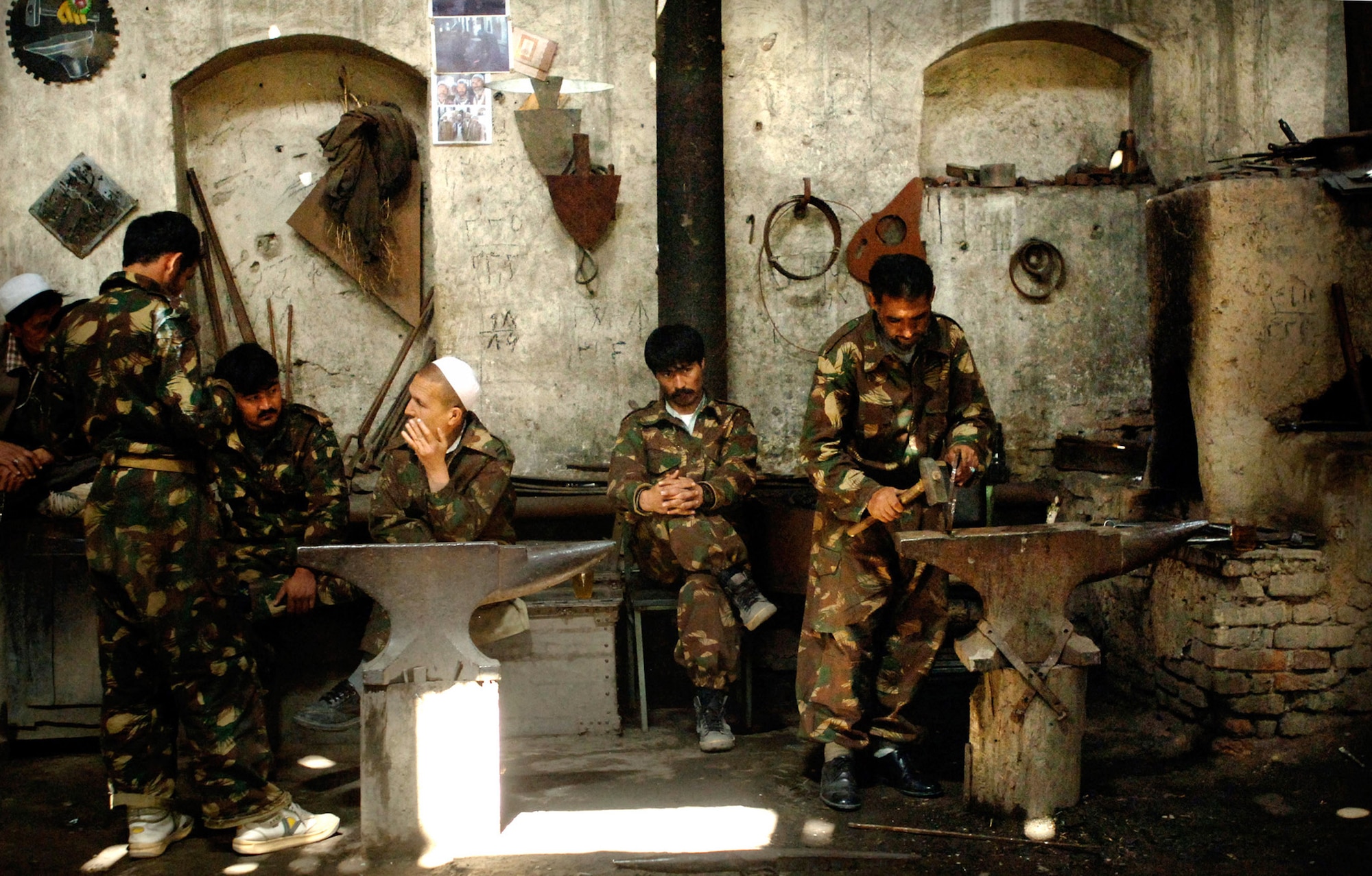 Afghan national army soldiers and civilian workers prepare metal work in an older warehouse in the central maintenance depot in Kabul, Afghanistan. Air Force embedded training team members are working on equipping ANA soldiers with better facilities by establishing a process that helps improve the ANA's logistical capabilities. (U.S. Air Force photo/Tech. Sgt. Cecilio M. Ricardo Jr.)
