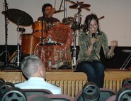 MINOT AIR FORCE BASE, N.D. -- Yarona Harel, lead vocalist for the Israeli musical group Esta, gets the crowd going at the base theater here May 12, as Col. Marty Whelan, 91st Space Wing commander, looks on. Esta was hosted by the Minot Area Council of the Arts as part of the Midwest World Fest, a cultural-exchange program that brings artists from around the world to entertain in America's heartland. (U.S. Air Force photo by Maj. Elizabeth Ortiz)