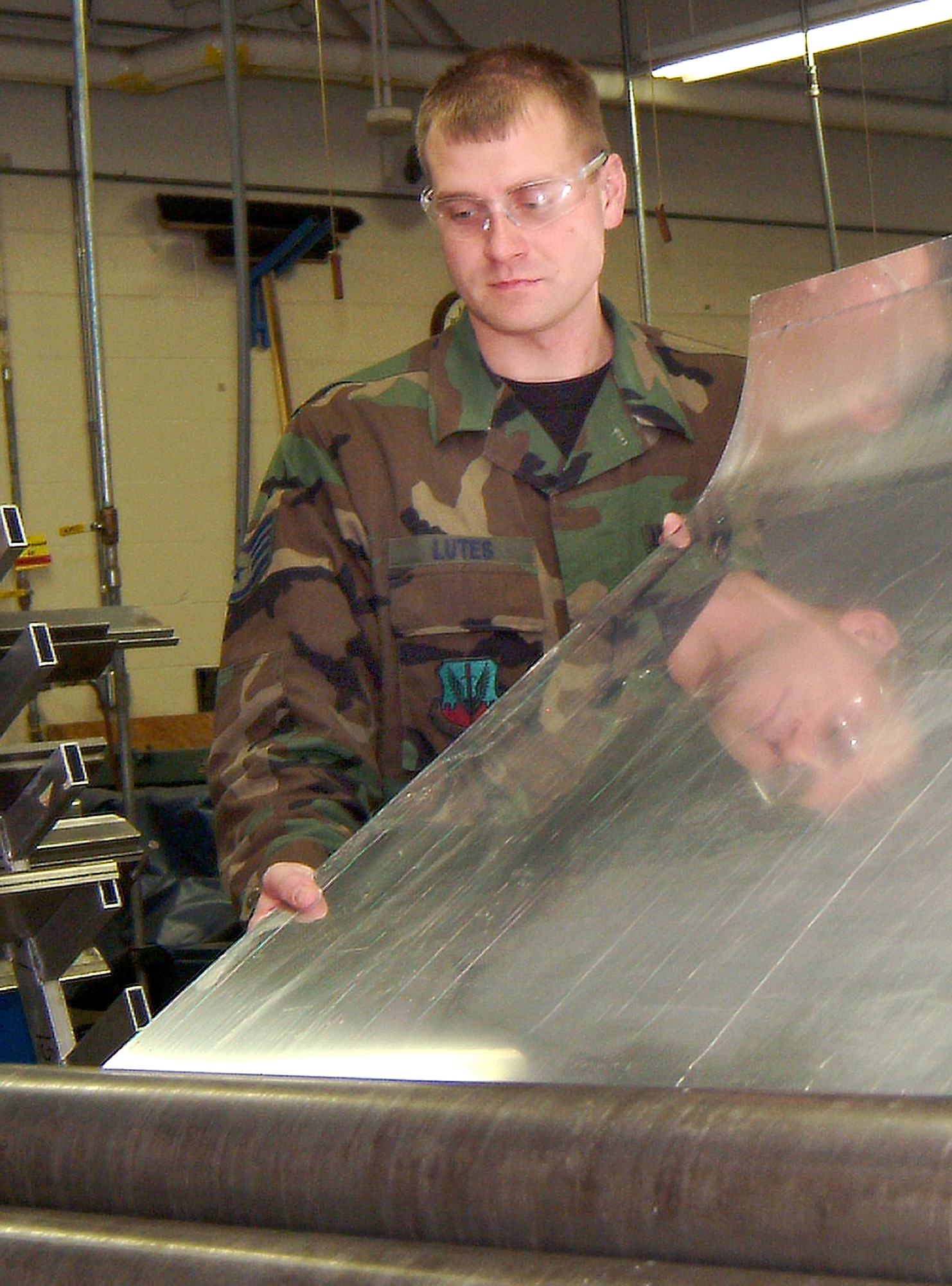 Using a sheet metal roller at the 139th Airlift Wing at Rosecrans Memorial Airport near St. Joseph, Mo.,  Staff Sgt. Jim Lutes, 442nd Maintenance Squadron structure shop, shapes a metal panel to replace a badly corroded and cracked floor removed from A-10 Thunderbolt II number 237.  The 442nd Fighter Wing did not have a roller large enough to accomplish the task and the 139th invited the Whiteman reservists to  come to the Missouri Air National Guard unit to use theirs. (U.S. Air Force photo/Master Sgt. William Huntington)