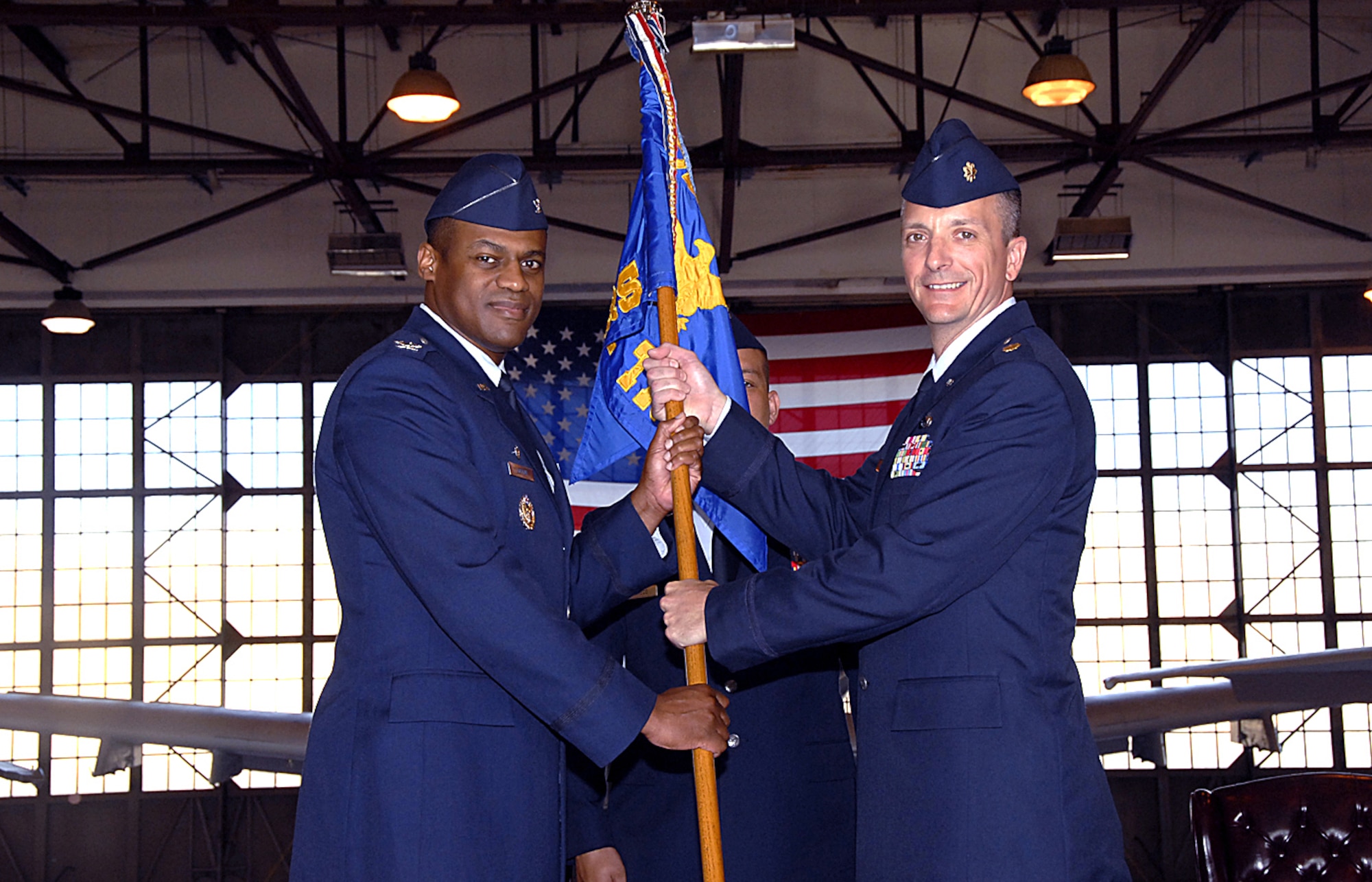 Presiding officer Col. Sam Lofton III, 82nd Training Group commander, hands over the guidon to Maj. Terry Koester, new commander of the 362d Training Squadron during the formal change-of-command ceremony May 14. Major Koester replaces Lt. Col. Teal Clark as the 362nd TRS commander.  (U.S. Air Force photo/Harry Tonemah)