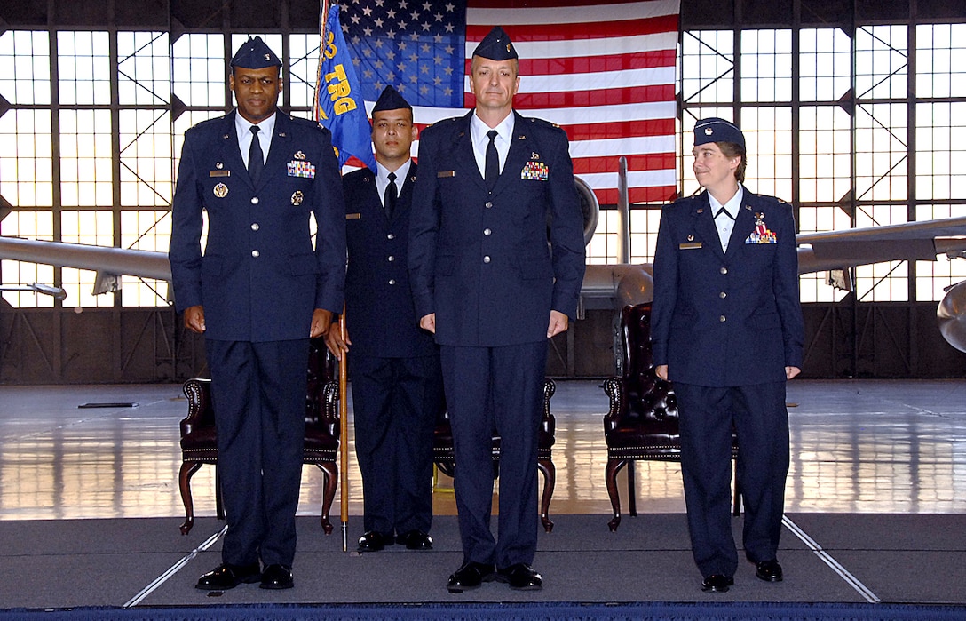 Col. Sam Lofton III, 82nd Training Group commander, stands with incoming 362nd Training Squadron Commander Maj. Terry Koester and outgoing commander Lt. Col. Teal Clark stand on the podium just after exchanging the guidon, formally transferring command of the 362 TRS May 14.  (U.S. Air Force photo/Harry Tonemah)