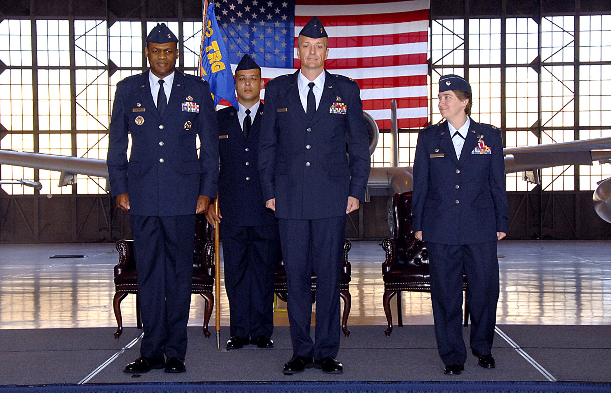 Col. Sam Lofton III, 82nd Training Group commander, stands with incoming 362nd Training Squadron Commander Maj. Terry Koester and outgoing commander Lt. Col. Teal Clark stand on the podium just after exchanging the guidon, formally transferring command of the 362 TRS May 14.  (U.S. Air Force photo/Harry Tonemah)