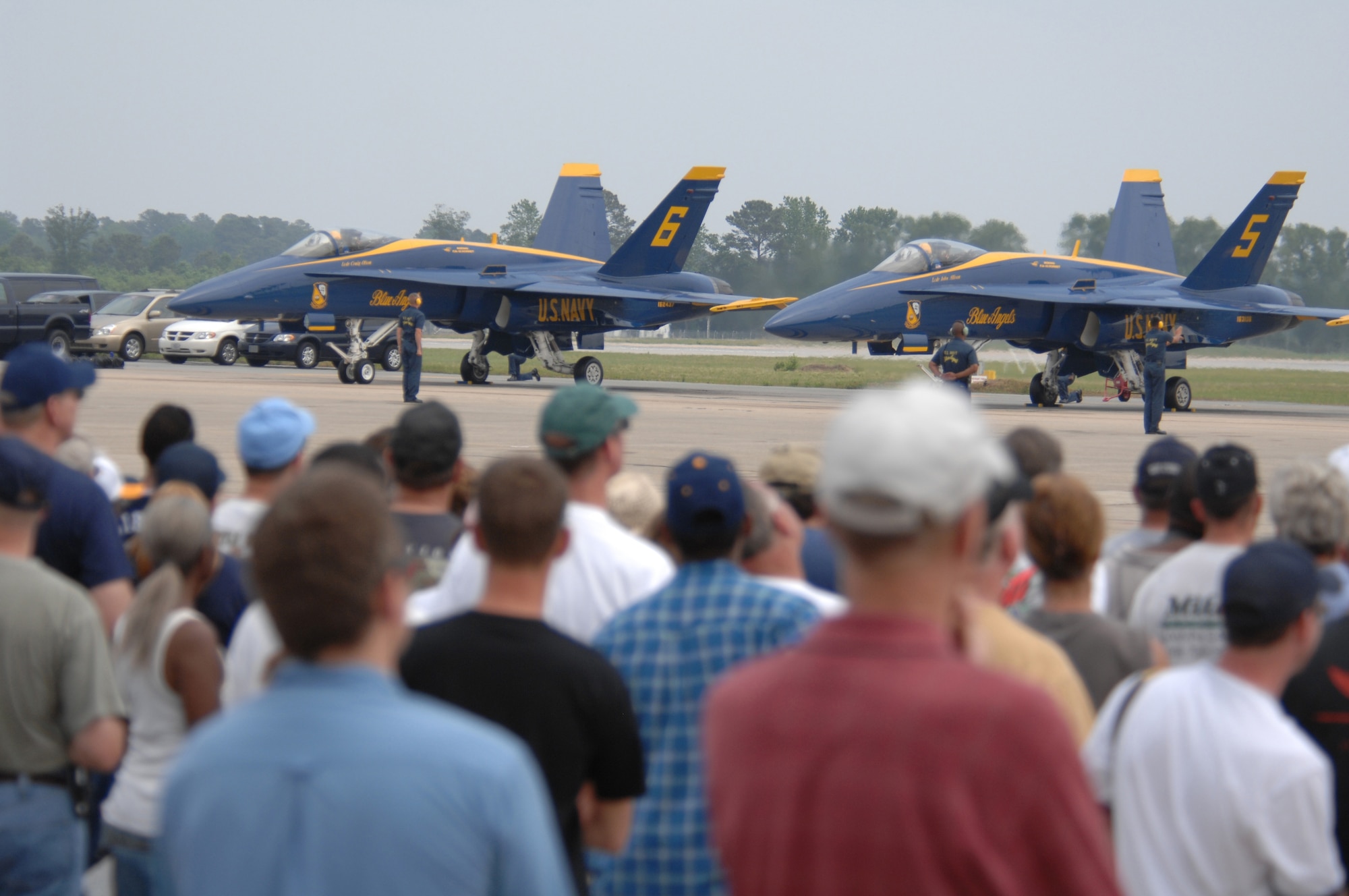 Spectators look on as the Navy Demonstration Team the Blue Angles prepare to taxi, at the Wings Over Wayne Airshow here May 12. The Wings Over Wayne Airshow 2007 is the first apperance of the Blue Angels since the accident that occurred April 21.(U.S. Air Force photo by Airman 1st Class Greg Biondo)(released)