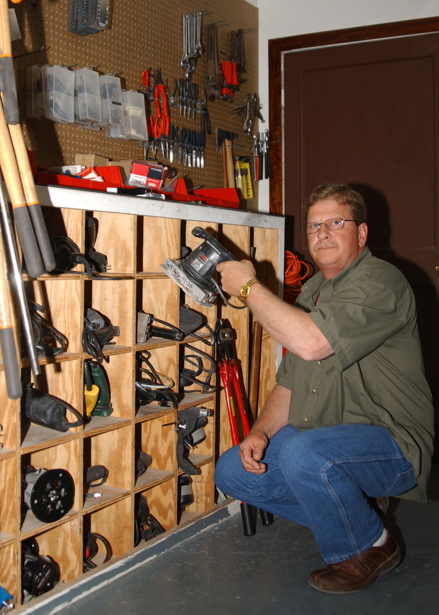 Perry Atchley, a Self-Help store employee, shows the many tools available at the Self-Help store May 7. The Self-Help store has available hammer drills, hand sanders, saws, and routers. (U.S. Air Force photo by Tech. Sgt. Patrick Hyde).