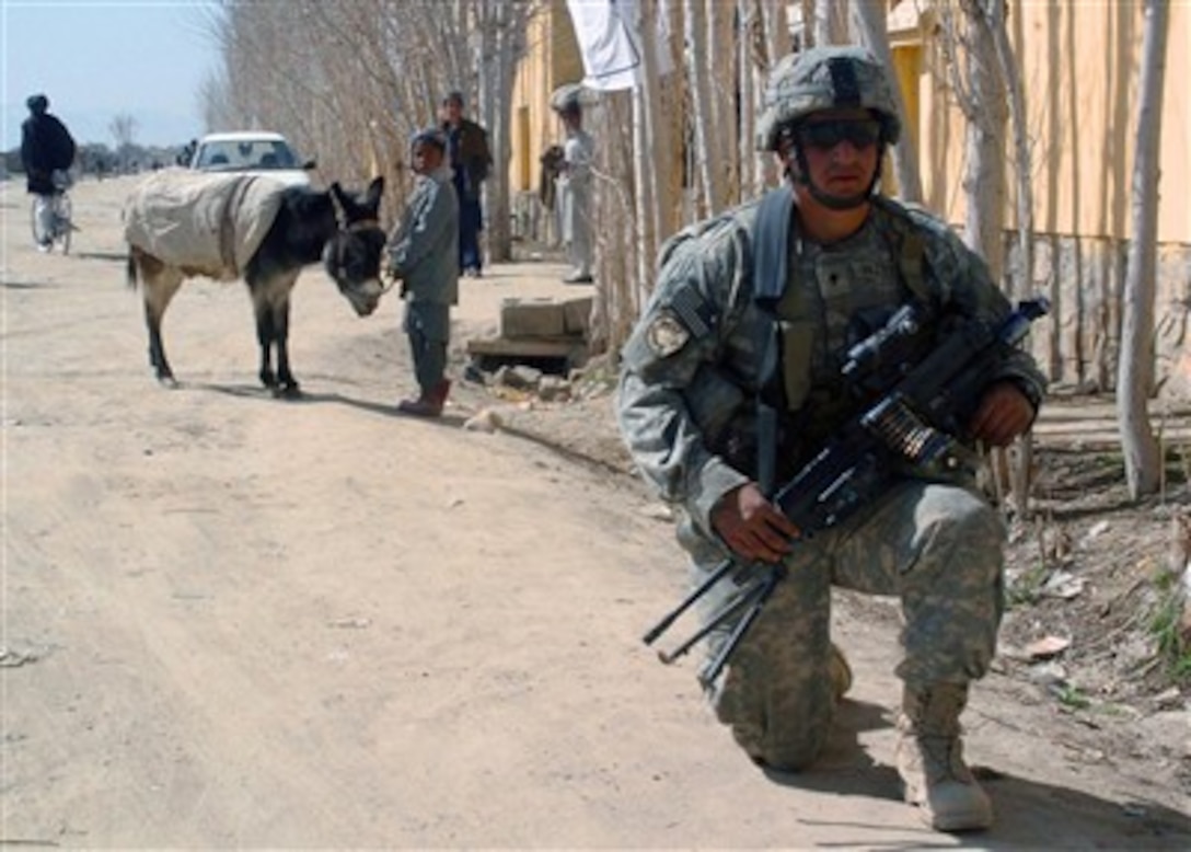 U.S. Army Spc. Alexander Vasquez provides security outside of the Miri district hospital in Ghazni province, Afghanistan, on March 6, 2007, during a visit to determine the facility's medical needs.  Vasquez is assigned as a squad automatic gunner in 3rd Platoon, Alpha Company, 2nd Battalion, 508th Parachute Infantry Regiment, 82nd Airborne Division.  