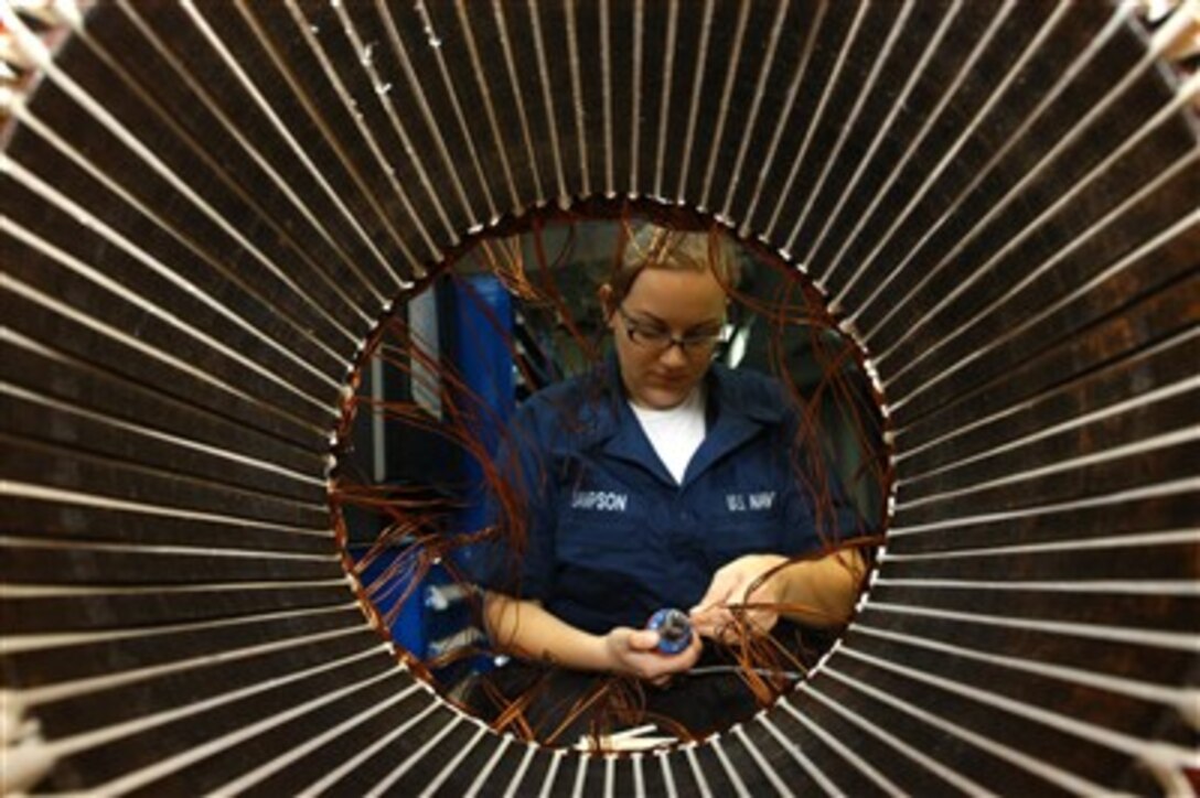 U.S. Navy Electrician's Mate Seaman Angela Sampson strips and spins wire on the number seven high pressure air compressor aboard the nuclear-powered aircraft carrier USS Nimitz (CVN 68) underway in the Indian Ocean on May 3, 2007.  