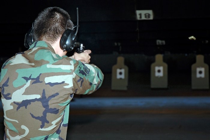 Staff Sgt. Jonathan Howard, 437th Security Forces Squadron, aims and shoots his 9 mm Berretta handgun at a target downrange during the security forces shootout competition at the shooting range May 15 as part of National Police Week. (U.S. Air Force photo/Staff Sgt. Marie Cassetty)