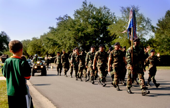 Members of the 437th Security Forces Squadron throw candy to Brendon Roach, son of Maj. Darren Roach, during a parade May 14 at Charleston AFB to kick off National Police Week.  (U.S. Air Force/ Airman 1st Class Nicholas Pilch) 