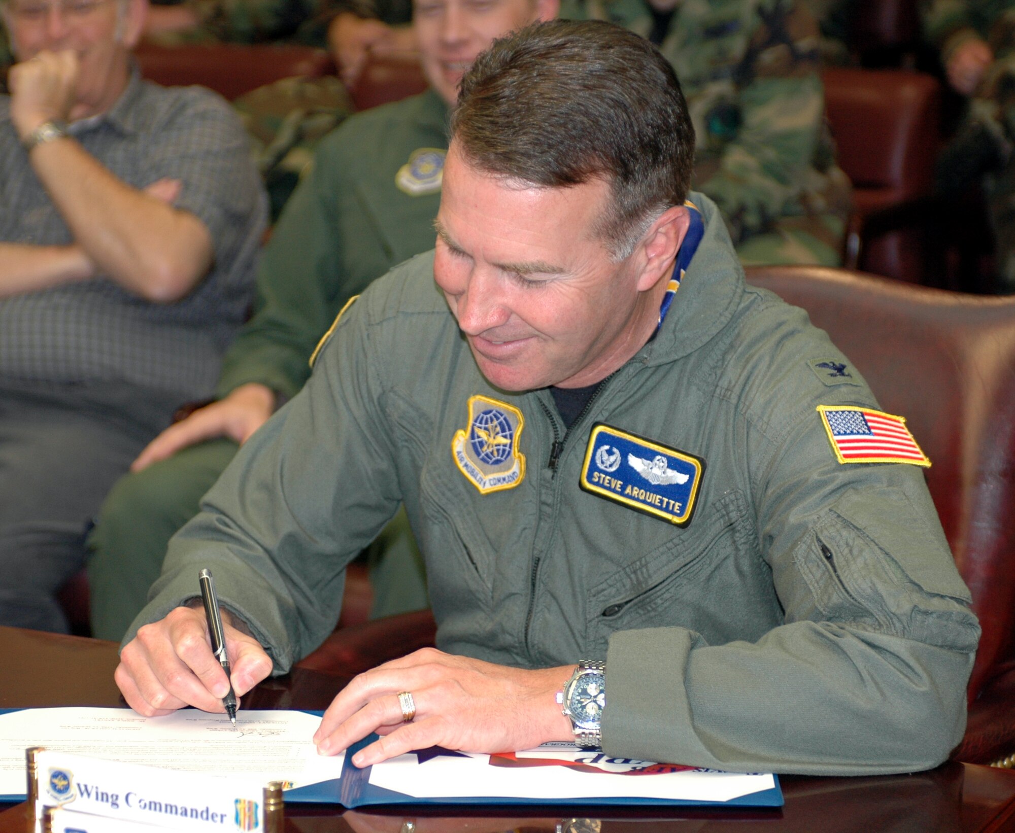 Col. Steve Arquiette, 60th Air Mobility Wing commander, signed the Voluntary Protection Program proclamation in front of several members of Team Travis May 4. The program is aimed at empowering all personnel to identify safety concerns and implement safety improvements. (U.S. Air Force photo by Staff Sgt. Candy Knight)
