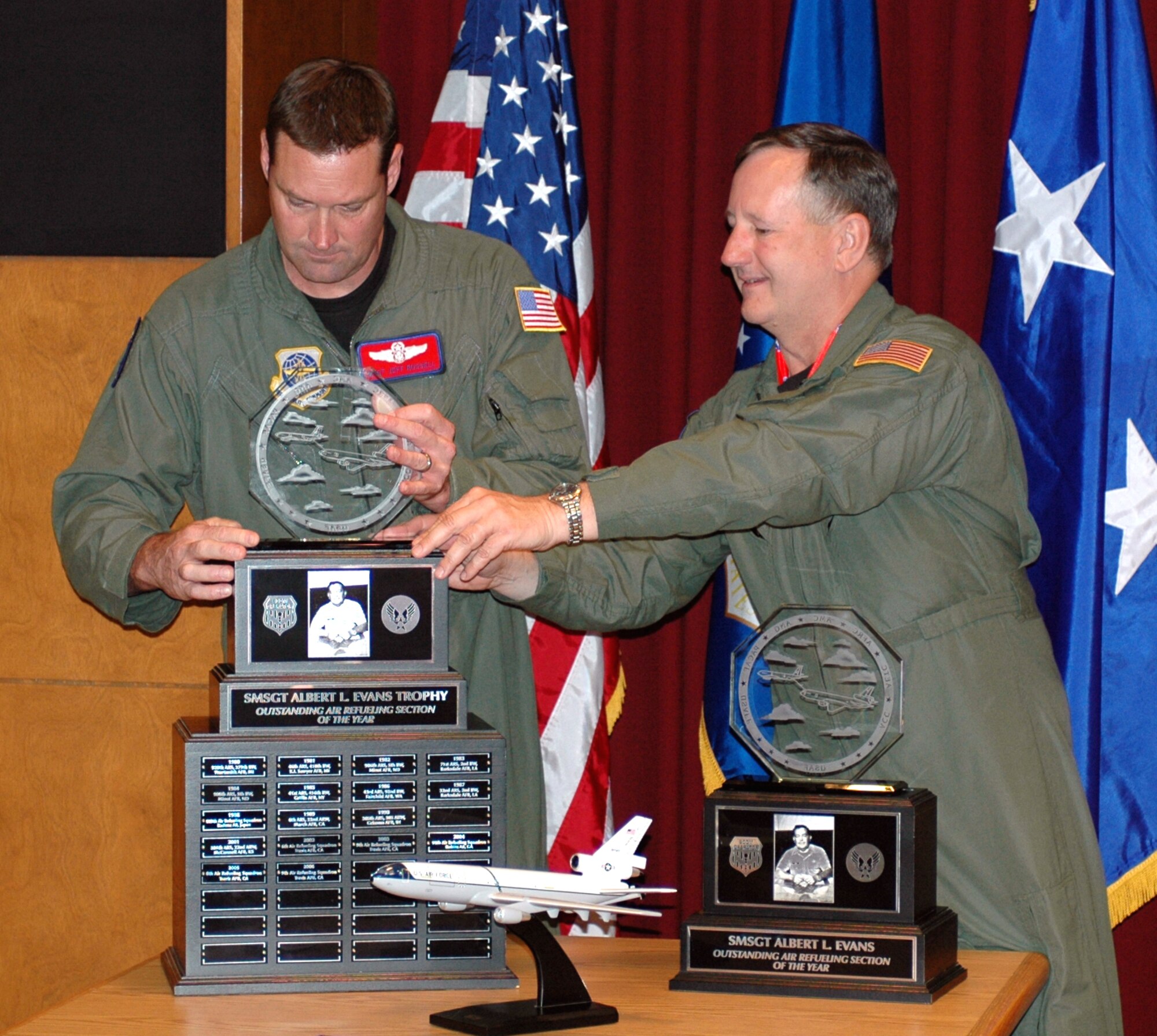 Maj. Gen. Fred Roggero, (right), Air Mobility Command Air, Space and Information Operations director, presents the Senior Master Sgt. Albert L. Evans Trophy to Master Sgt. Jeff Russell, 9th Air Refueling Squadron chief boom operator, during a ceremony May 14. The trophy is awarded to the Top Boom Operators in Air Mobility Command. (U.S. Air Force photo by 1st Lt. Lindsey Hahn)
