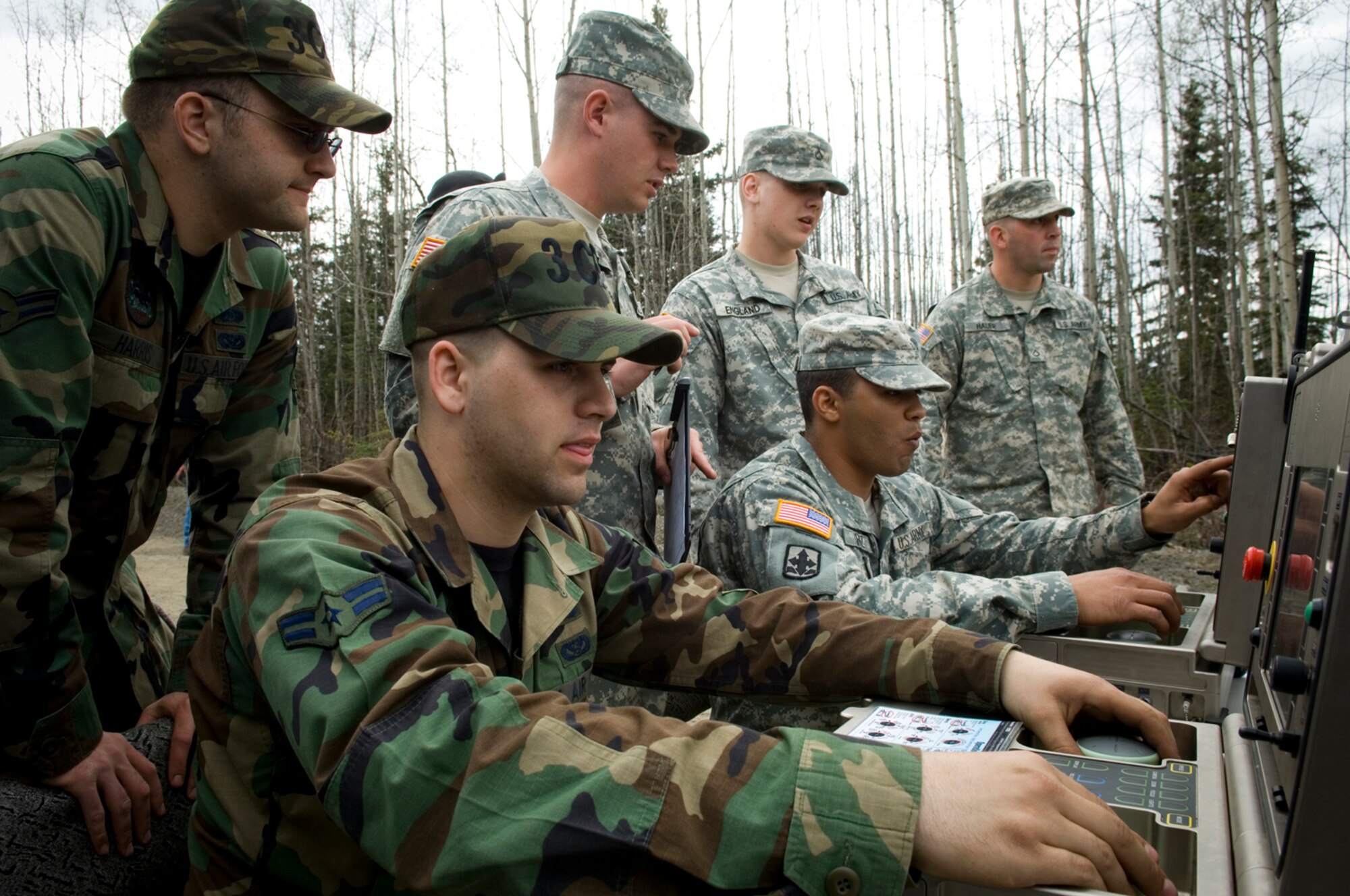 Anchorage, AK – U.S. Army and Air Force personnel send commands to Unmanned Ground Vehicles (UGV) investigating potential hazardous material discovered during Alaska Shield/Northern Edge. Exercise Alaska Shield / Northern Edge 07 is a state of Alaska / US Northern Command sponsored homeland defense / defense support of civil authorities exercise; part of the national-level Ardent Sentry / Northern Edge 07 exercise.  Photo by Senior Airman Garrett Hothan.