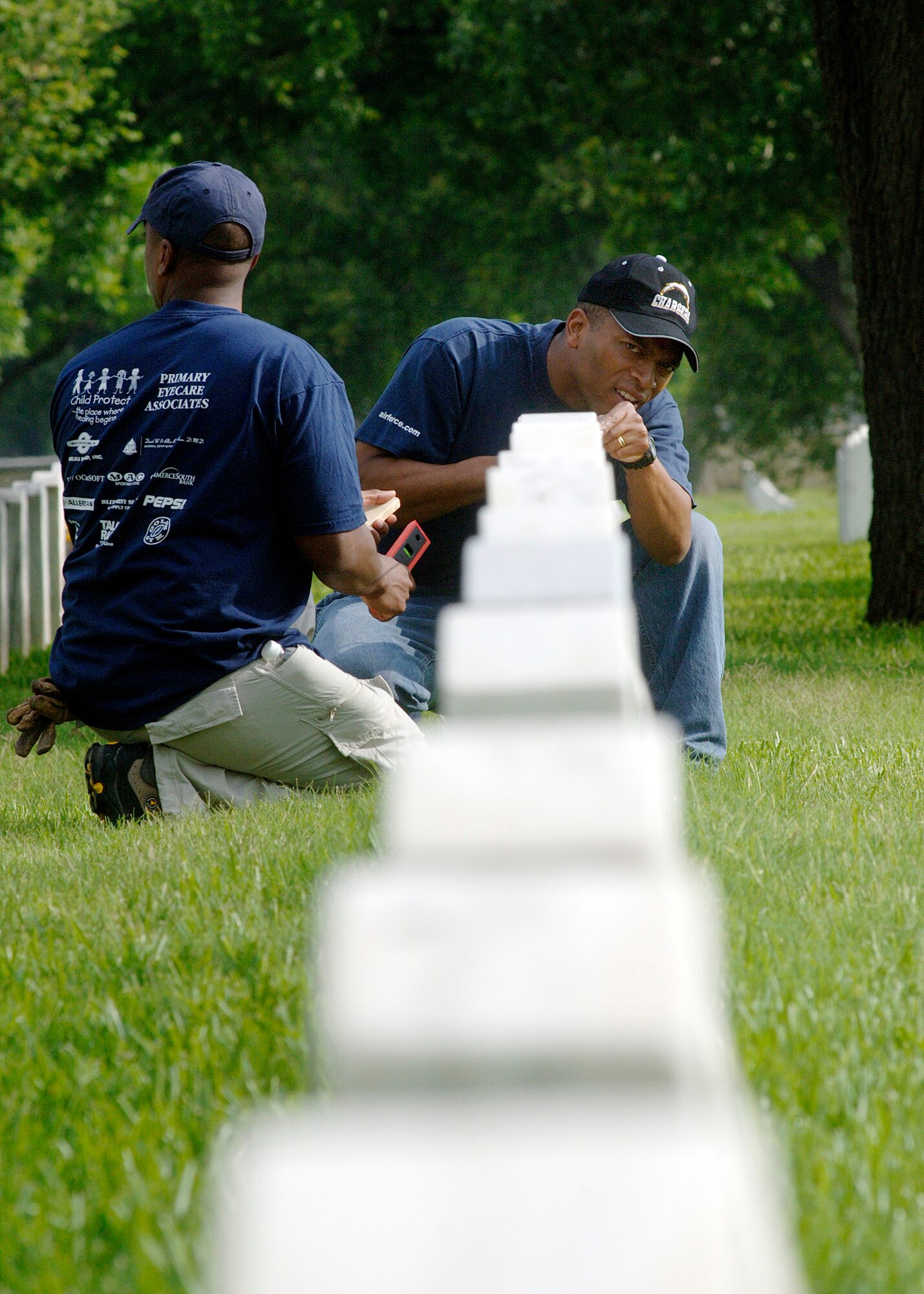 Airmen volunteers straighten headstones May 15 at the Fort Sam Houston National Cemetery in San Antonio. This process aligns and straightens all the headstones and prepares the cemetery for funerals and the upcoming Memorial Day weekend. Airmen assigned to the Air Force News Agency in San Antonio spent the day adjusting the headstones. (U.S. Air Force photo/Tech. Sgt. Larry A. Simmons)