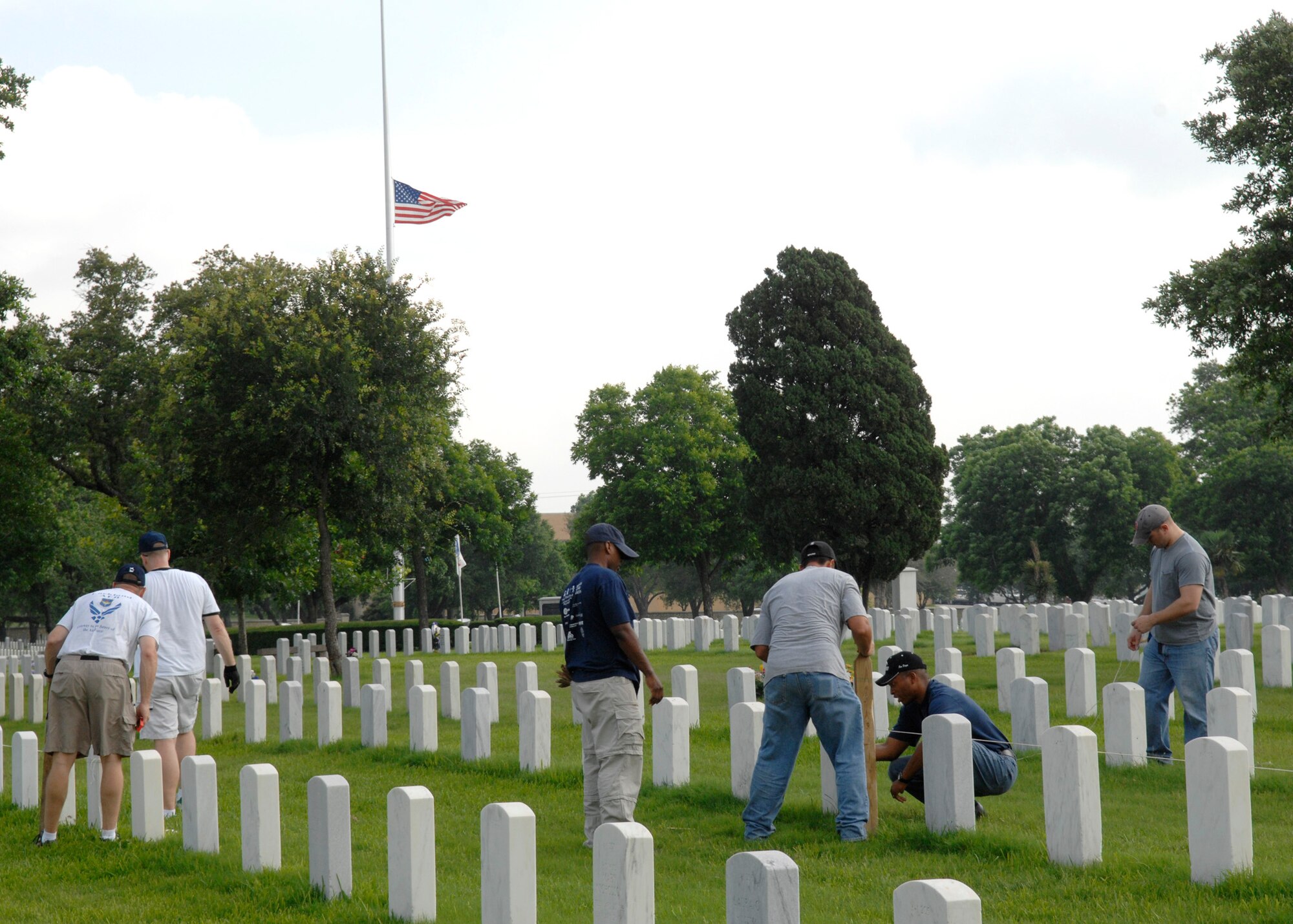 Airmen volunteers straighten headstones May 15 at the Fort Sam Houston National Cemetery in San Antonio. This process aligns and straightens all the headstones and prepares the cemetery for funerals and the upcoming Memorial Day weekend. Airmen assigned to the Air Force News Agency in San Antonio spent the day adjusting the headstones. (U.S. Air Force photo/Tech. Sgt. Larry A. Simmons)