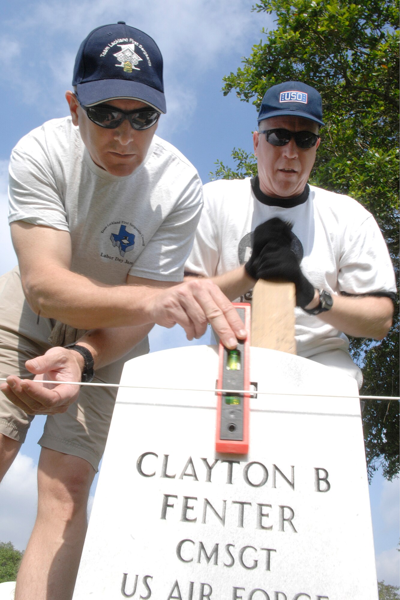 Senior Master Sergeants Scott Wilcox and Scott Gomer straighten headstones May 15 at the Fort Sam Houston National Cemetery in San Antonio. This process aligns and straightens all the headstones and prepares the cemetery for funerals and the upcoming Memorial Day weekend. Sergeants Gomer and Wilcox are assigned to the Air Force News Agency in San Antonio. (U.S. Air Force photo/Tech. Sgt. Larry A. Simmons)