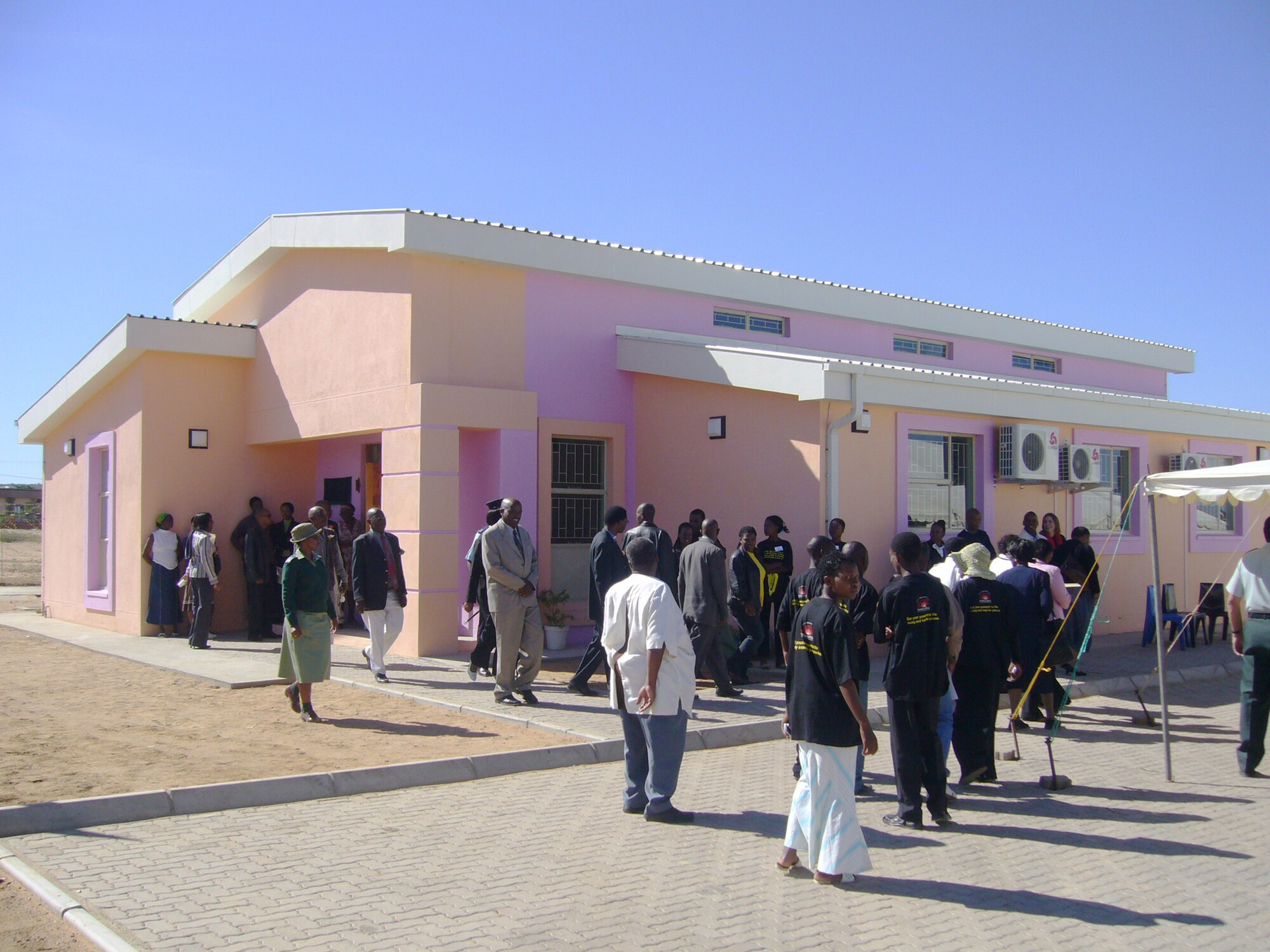 People tour their new volunteer AIDS counseling and testing center, which opened May 9 at Molepole, Botswana. The center is one of five other centers aimed at mitigating the effects of the HIV virus. In addition to the counseling and testing centers, the DOD is helping build orphan daycares and youth centers for orphans and children of all ages. According to recent estimates, 17.1 percent of Botswana's 1.7 million people are HIV-positive. (U.S. Air Force photo/Master Sgt. James Clark)