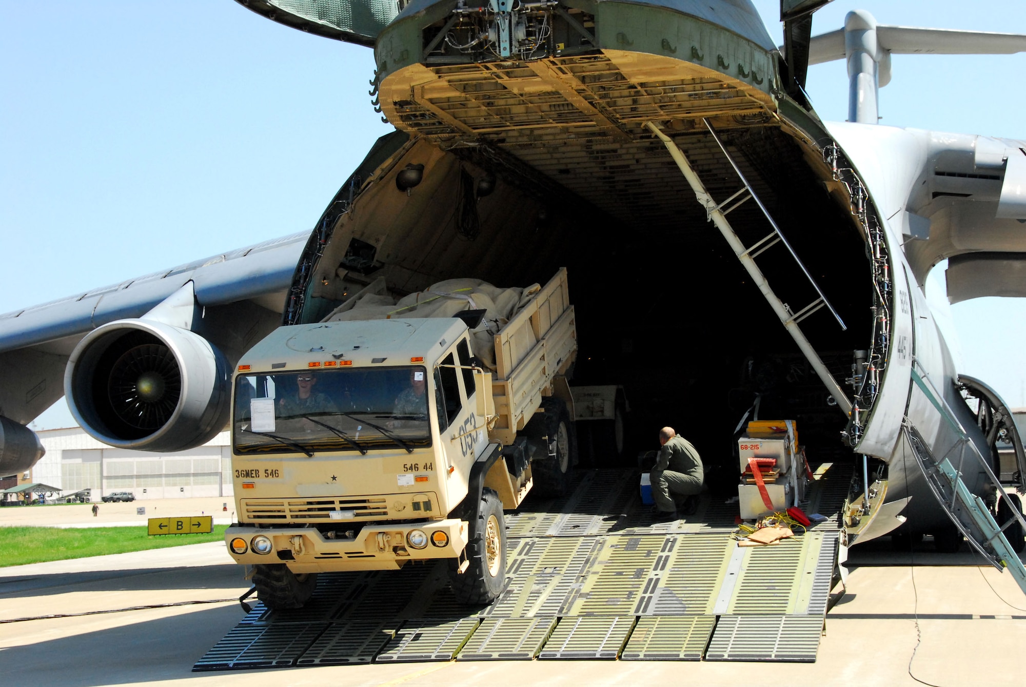 Army personnel off-load trucks May 12 from a C-5 Galaxy at Hulman Field in Terre Haute, Ind., in support of Exercise Ardent Sentry. Ardent Sentry is designed to hone coordination between the Department of Defense as well as federal, state, local and private agencies in a series of challenging scenarios ranging from natural disasters to terrorist incidents. (U.S. Air Force photo/Senior Master Sgt. John S. Chapman)