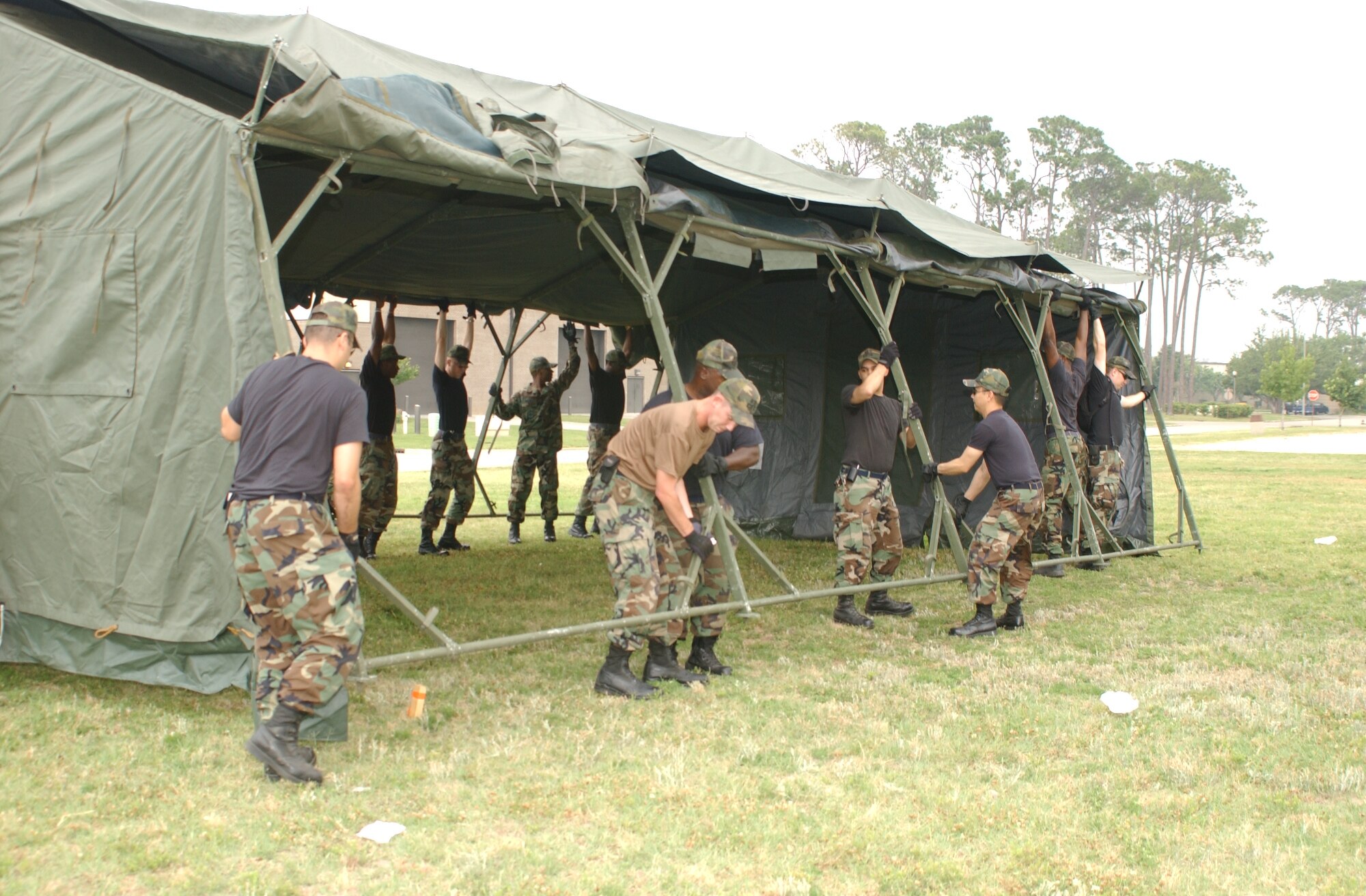 Members of the 81st Civil Engineer Squadron and 81st Services Division assemble 10 temper tents May 15 for next week’s exercise. (U. S. Air Force photo by Kemberly Groue)