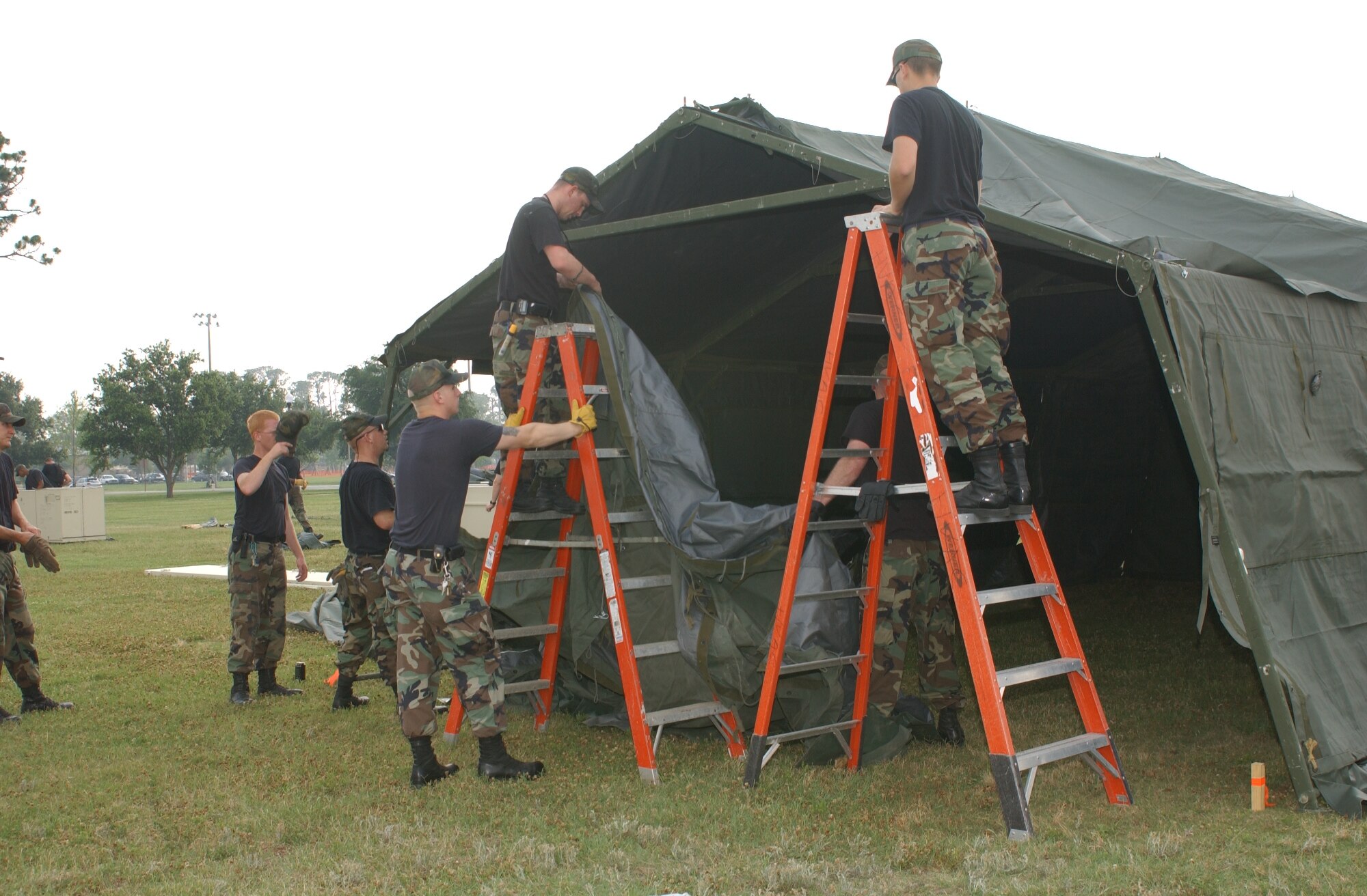 Members of the 81st Civil Engineer Squadron and 81st Services Division assemble 10 Temper tents, May 15 for next week’s exercise. (U.S. Air Force Photo by Kemberly Groue)