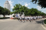 Col. Richard Clark (front center), 12th Flying Training Wing commander, leads unit members in a 1.5-mile run May 15 to kick off the 101 Critical Days of Summer campaign. After the run, the more than 200 participants were treated to food and beverages on Grater Field. (U.S. Air Force photo by Rich McFadden)