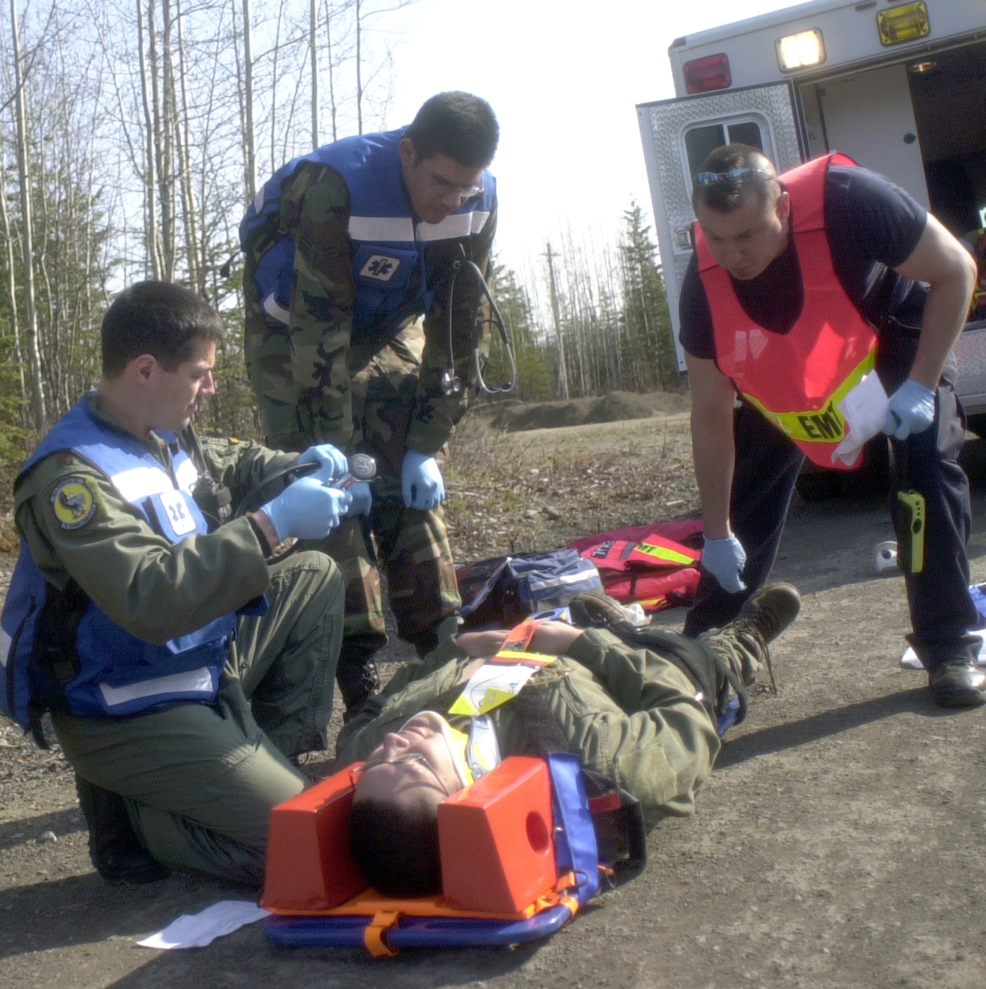 ELMENDORF AIR FORCE BASE, Alaska – First responders work together to save lives in response to a simulated train on bus collision as part of the Alaska Shield/Northern Edge 2007 exercise.  Military and civilian emergency medical technicians partnered to transport the simulated victims to medical facilities for treatment. Alaska Shield/Northern Edge is a state of Alaska and U.S. NORTHCOM-sponsored homeland defense exercise involving federal, state, local and private agencies.  In each scenario of the exercise, communication and cooperation between authorities at all levels are challenged as military and civilians work hand-in-hand to respond to both natural and man-made crises. (Air Force photo by Staff Sgt. J.G. Buzanowski)