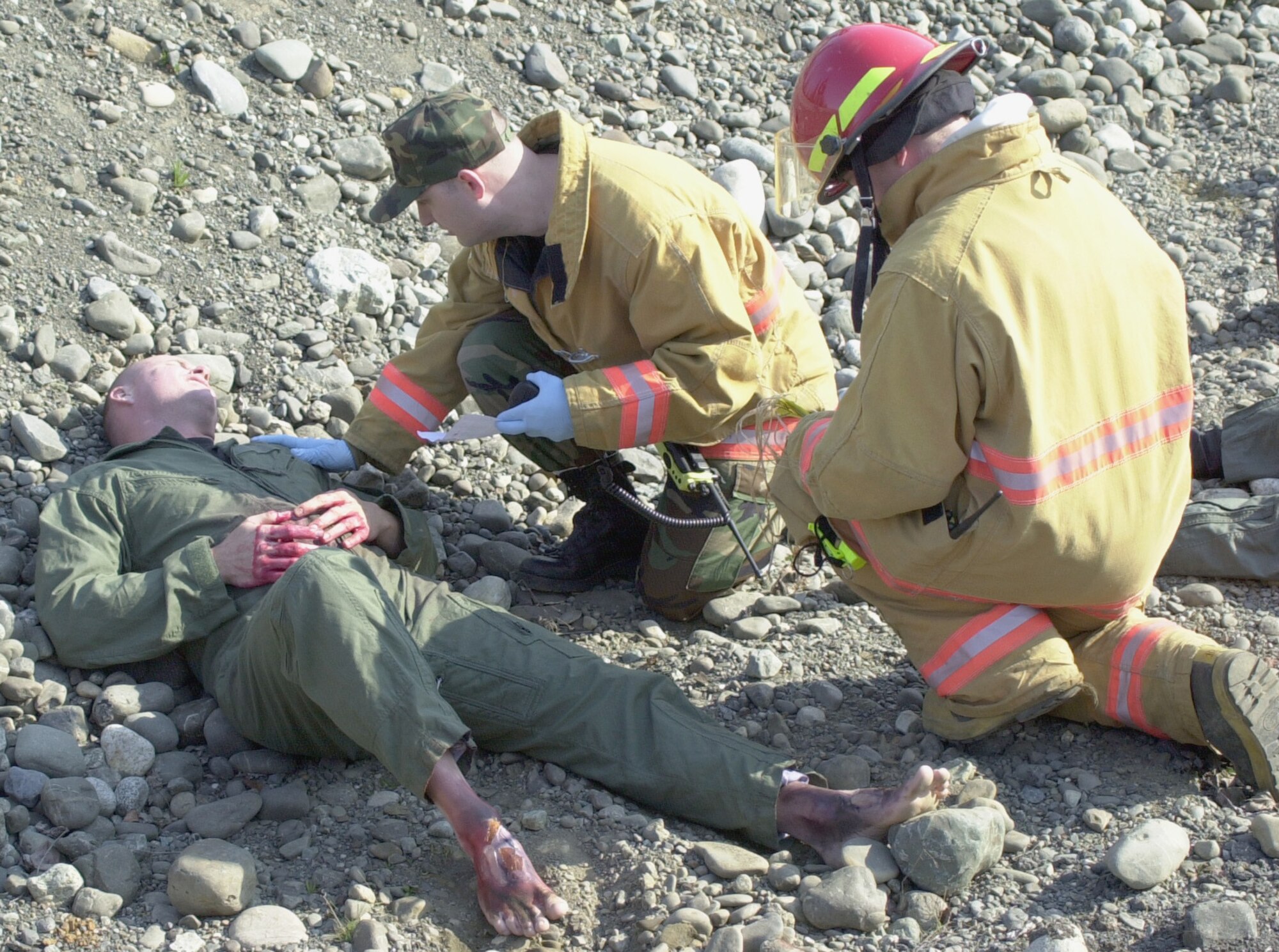 ELMENDORF AIR FORCE BASE, Alaska – Firefighters from Elmendorf Air Force Base’s 3rd Wing attend to a simulated victim of a train collision May 15 as part of the Alaska Shield/Northern Edge 2007 exercise.  The May 15 scenario involved civilian and military first responders reacting to an Alaska Railroad train colliding with a bus on Elmendorf.  Alaska Shield/Northern Edge is a state of Alaska and U.S. NORTHCOM-sponsored homeland defense exercise involving federal, state, local and private agencies.  In each scenario of the exercise, communication and cooperation between authorities at all levels are challenged as military and civilians work hand-in-hand to respond to both natural and man-made crises.  (Air Force photo by Staff Sgt. J.G. Buzanowski)