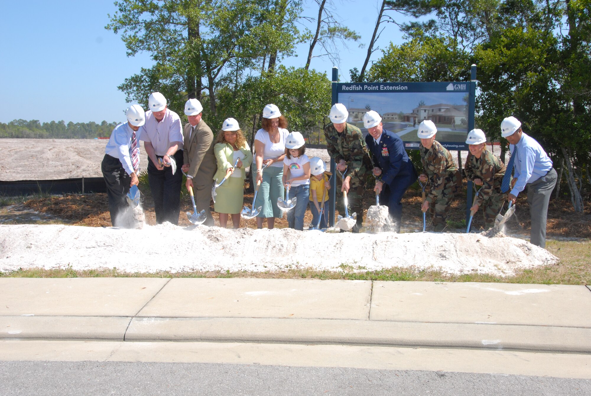 GMH Military Housing employees , a Tyndall Airman and his family and base leadership 'break ground' on the new privatized housing development here May 10. (Photo by Lisa Norman)