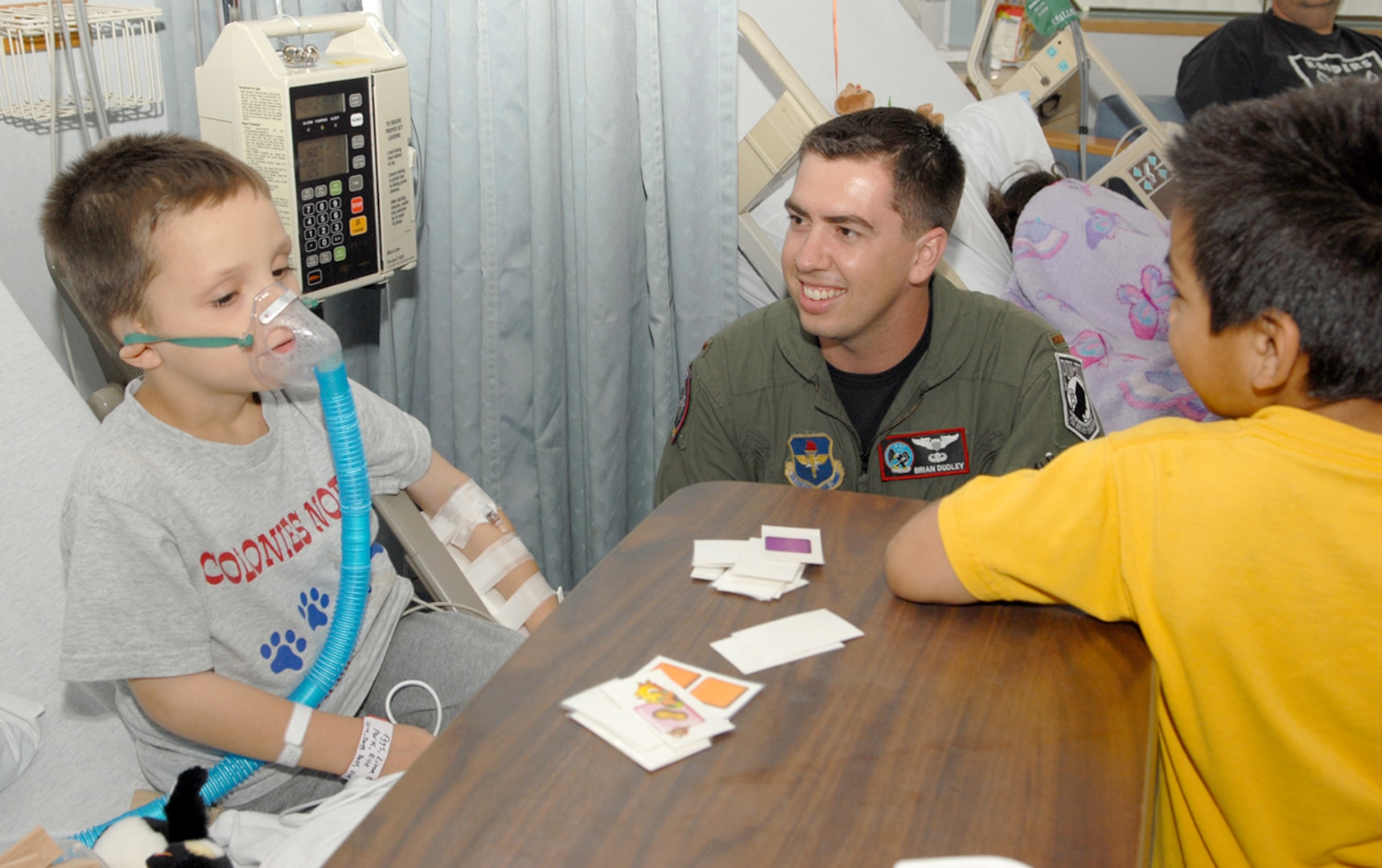 Second Lt. Brian Dudley (center), 435th Fighter Training Squadron fighter fundamentals student, spends time with children at the Methodist Hospital's Pediatric Oncology and Hematology unit recently. (U.S. Air Force photo by Don Lindsey)
