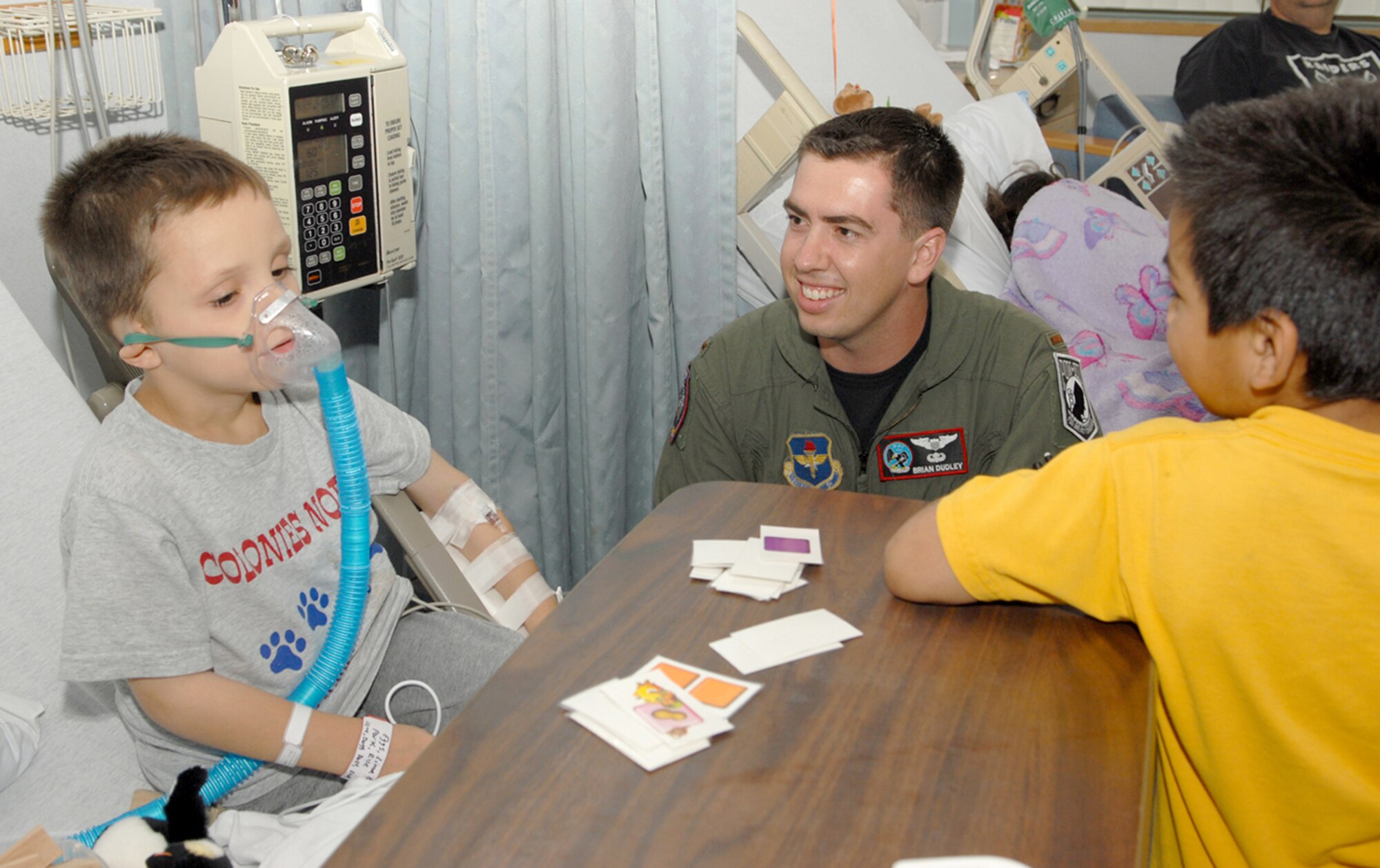 Second Lt. Brian Dudley (center), 435th Fighter Training Squadron fighter fundamentals student, spends time with children at the Methodist Hospital's Pediatric Oncology and Hematology unit recently. (U.S. Air Force photo by Don Lindsey)