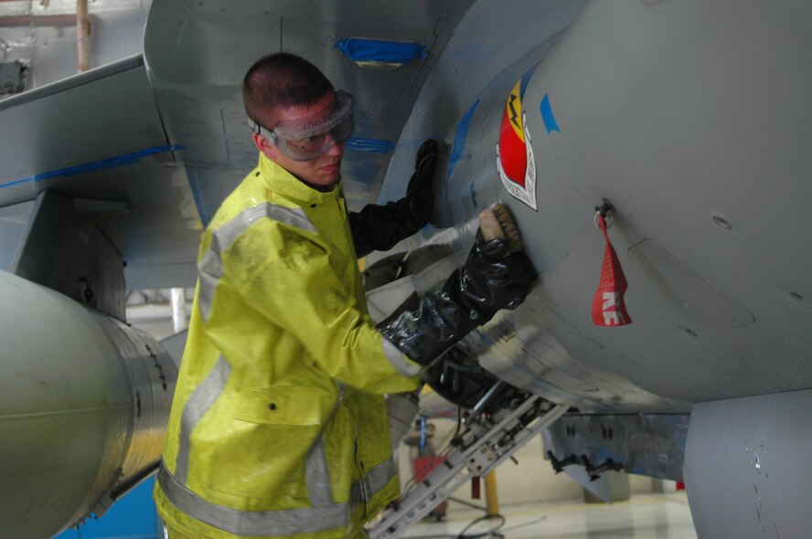Senior Airman Jacob Bohmert, 4th Aircraft Maintenance Unit crew chief, scrubs the F-16 Fighting Falcon he maintains in a wash bay April 26.  Every 120 days the 388th Fighter Wing?s F-16s are washed to prevent paint chips and other types of corrosion.