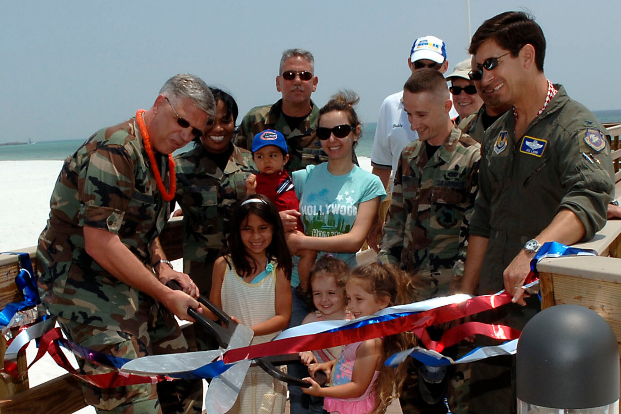 Col. Dean Clemons, 96th Air Base Wing commander, cuts the ribbon at Eglin's Beach Park while Col. Joe Lanni, Air Armament Center vice commander. The beach park officially opened May 11 and is open to all Department of Defense identification card holders.