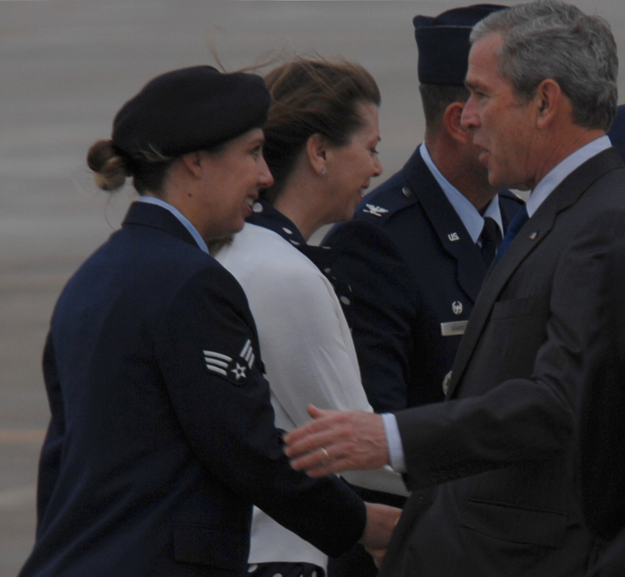 Senior Airman Nicole O'Hara, 1st Security Forces Squadron entry controller, greets President George W. Bush on his arrival here May 13. The president and his wife, first lady Laura Bush, landed at Langley and then boarded Marine One to attend America’s Anniversary Weekend at Jamestown. (U.S. Air Force photo/Senior Airman Tabitha Kuykendall)