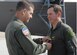 Col. Mark Barrett, 1st Fighter Wing commander, presents Col. Thomas Bergeson, acting 1st FW vice commander and previous 1st Operations Group commander, with the Legion of Merit medal after his “fini” flight here May 11. Colonel Bergeson recently deployed to Baghdad May 14 for a one-year tour. (U.S. Air Force photo /Staff Sgt. Katrina Shellman)