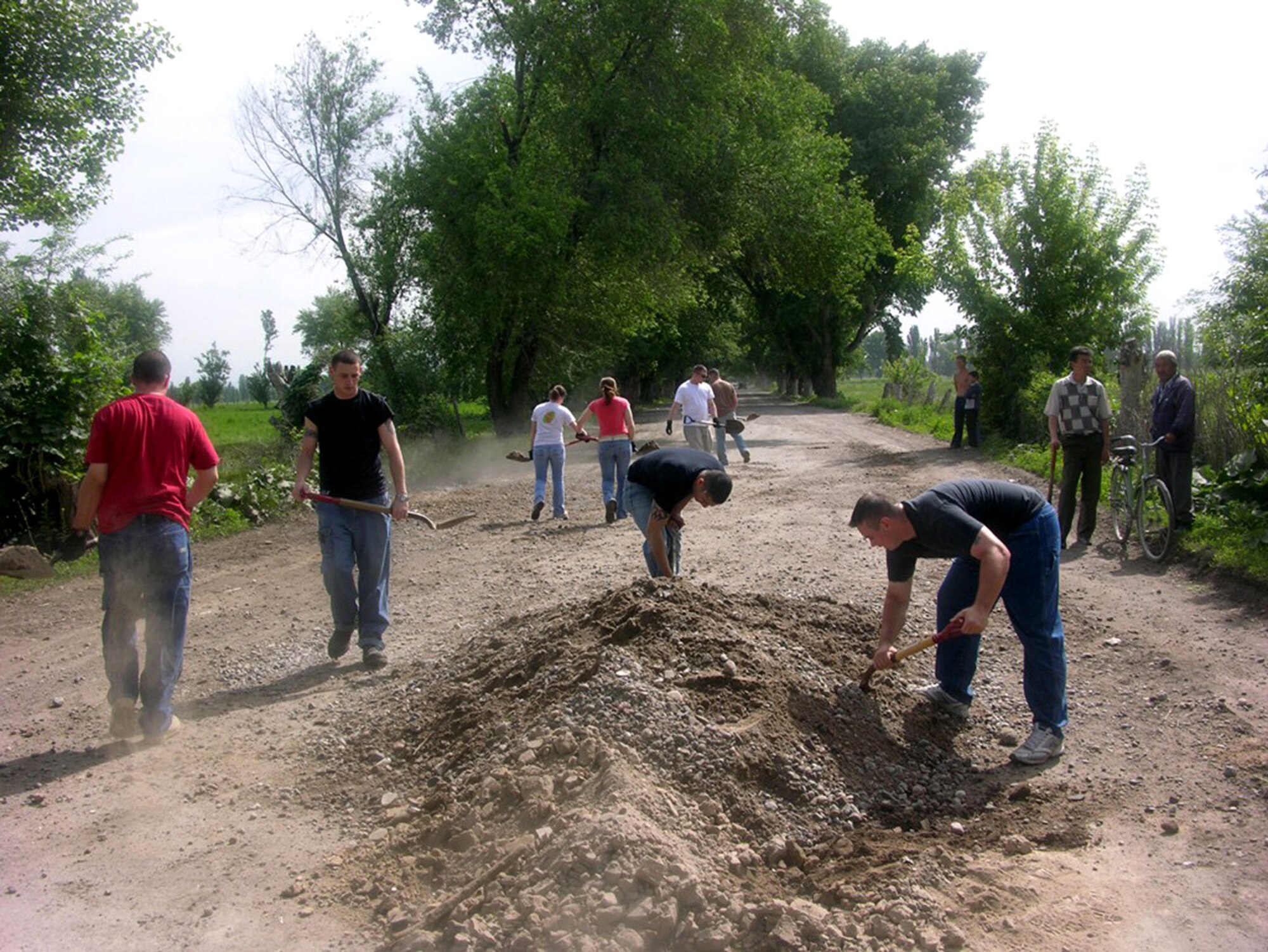 Airmen from the 376th Expeditionary Security Forces Squadron and 376th Expeditionary Comptroller Squadron fill in potholes and other hazardous road safety conditions May 11 in and around the village of Oktyabrskoye, Kyrgyzstan. Oktyabrskoye is one of six villages that has a working partnership with Manas Air Base, Kyrgyzstan. (Courtesy photo) 
