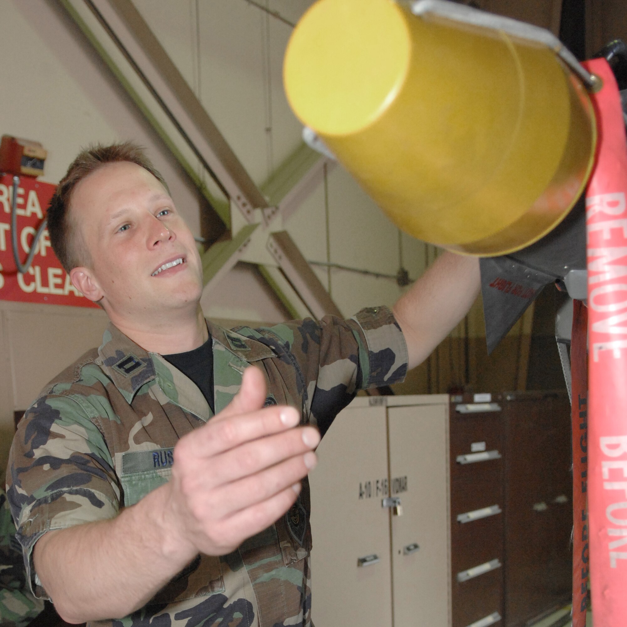 Capt. Nathan Rusin, an Instructor assigned to the 19th Weapons School, prepares to examine the nose of a air to air missle Monday May 14, 2007 Nellis AFB, Nevada.(U.S Air Force Photo by: Senior Airman Larry E. Reid Jr.)