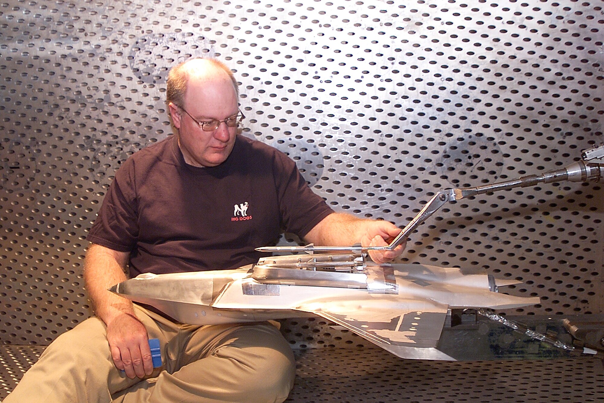 Northrup Gruman Model Technician Dale Metzler installs a dummy store on a 15 percent F-35 Joint Strike Fighter model during a model change. The JSF is being tested in the Arnold Engineering Development Center’s 4-foot transonic wind tunnel.