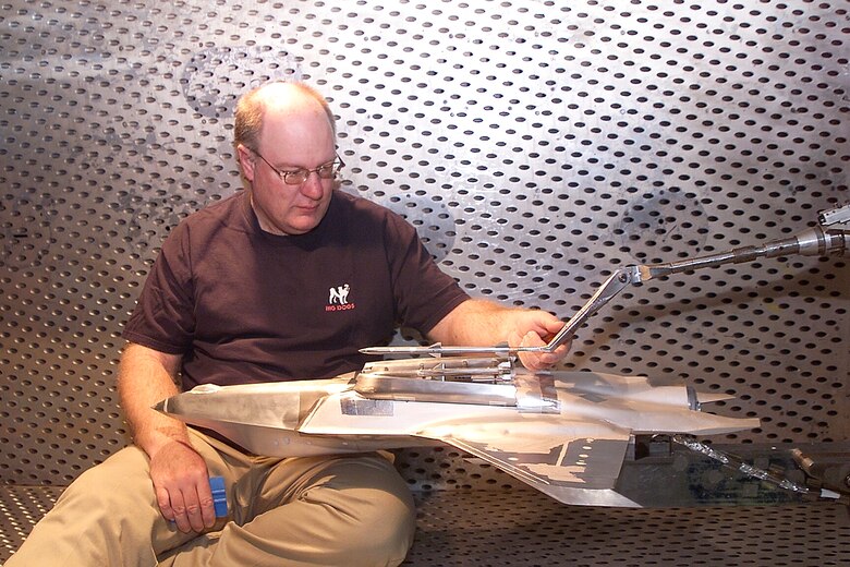 Northrup Gruman Model Technician Dale Metzler installs a dummy store on a 15 percent F-35 Joint Strike Fighter model during a model change. The JSF is being tested in the Arnold Engineering Development Center’s 4-foot transonic wind tunnel.