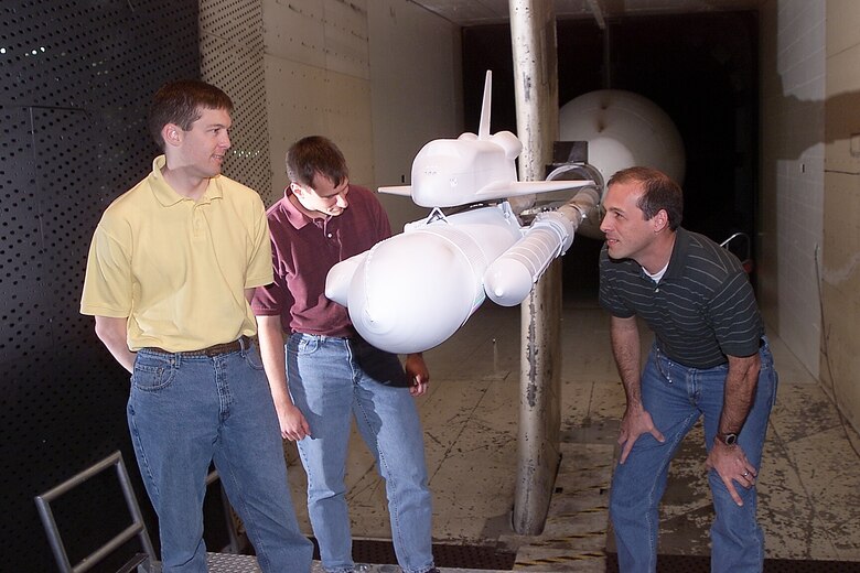 Jim Greathouse, CFD analyst, left to right, Darby Vicker, CFD analyst, and Bob Ess, program manager, all from NASA Johnson Space Center, examine the shuttle model during a model change at AEDC’s 16-foot transonic wind tunnel. 