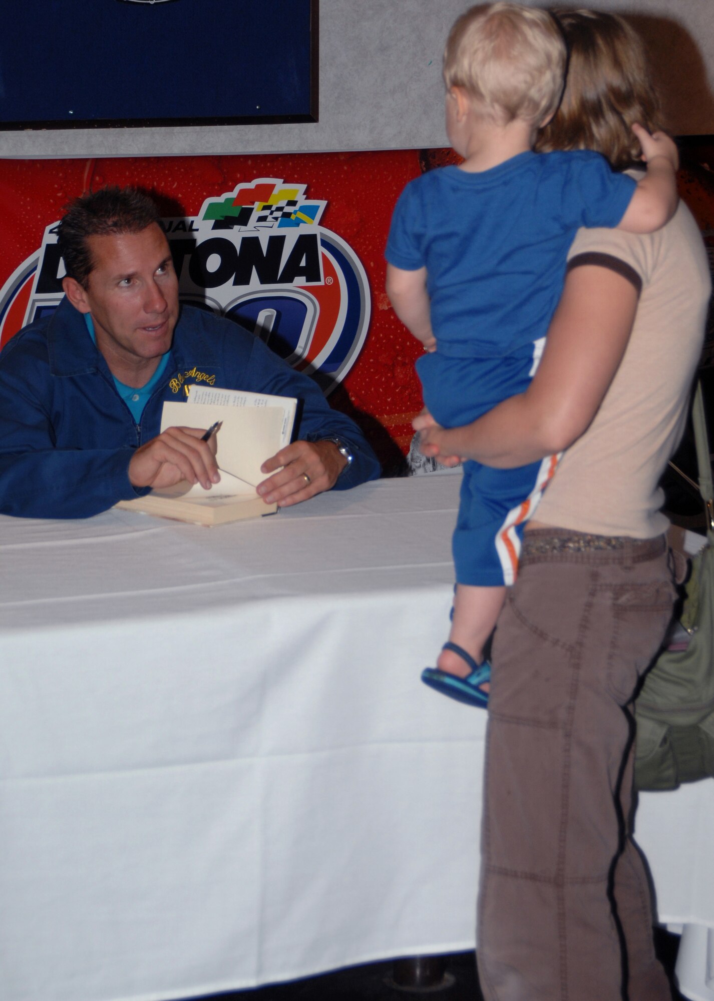 Nicholas Sparks, author of such works as ?The Notebook? and ?A Walk to Remember,? signs autographs for Team Seymour members and their families May 9 at the enlisted club, Seymour Johnson AFB, North Carolina.